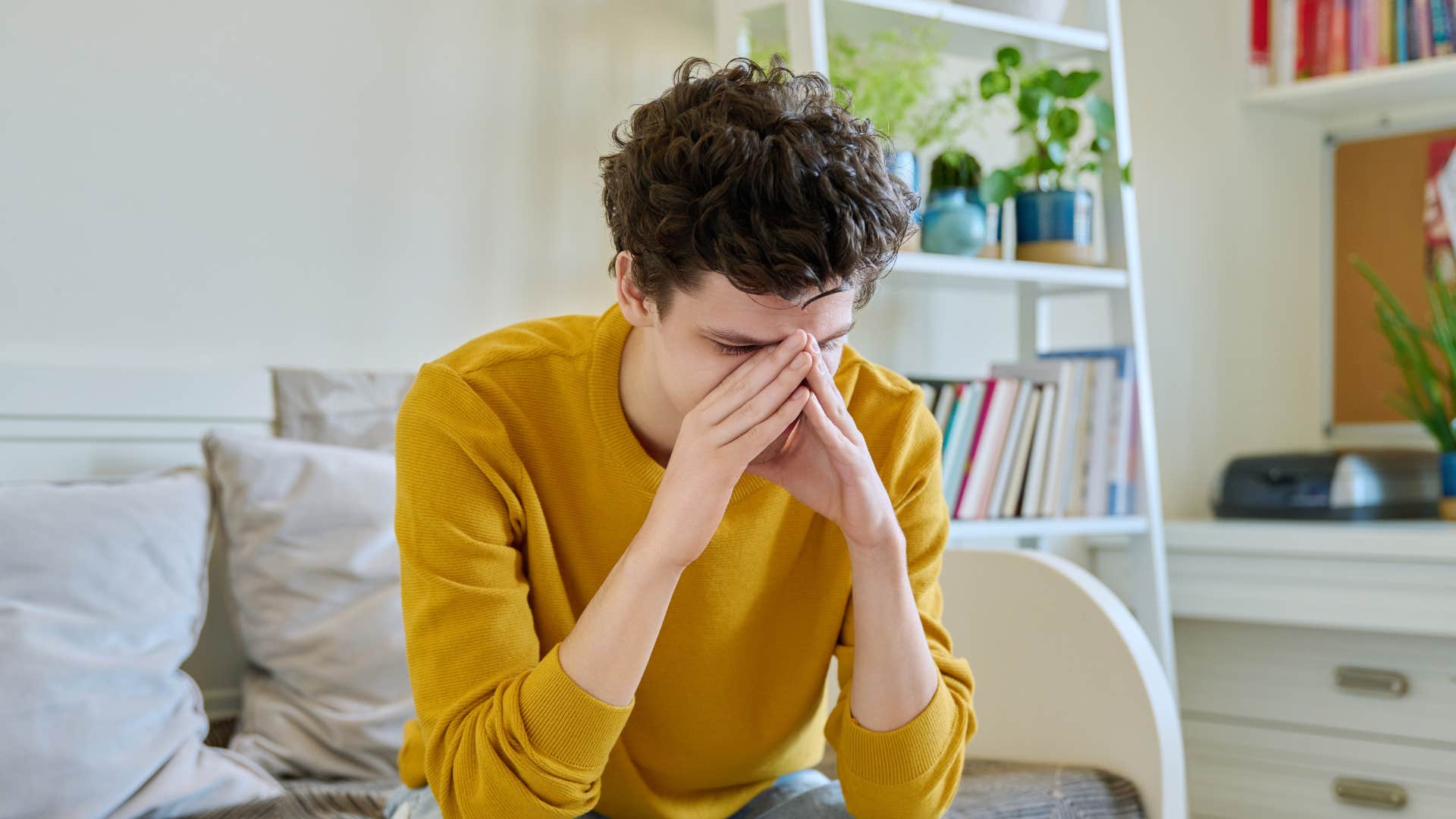 man looking sad feeling powerless sitting on couch