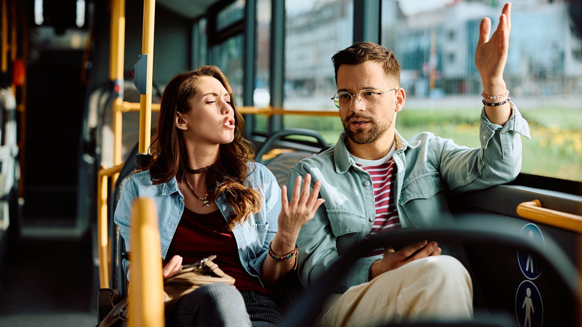 man on bus feeling unappreciated arguing with woman