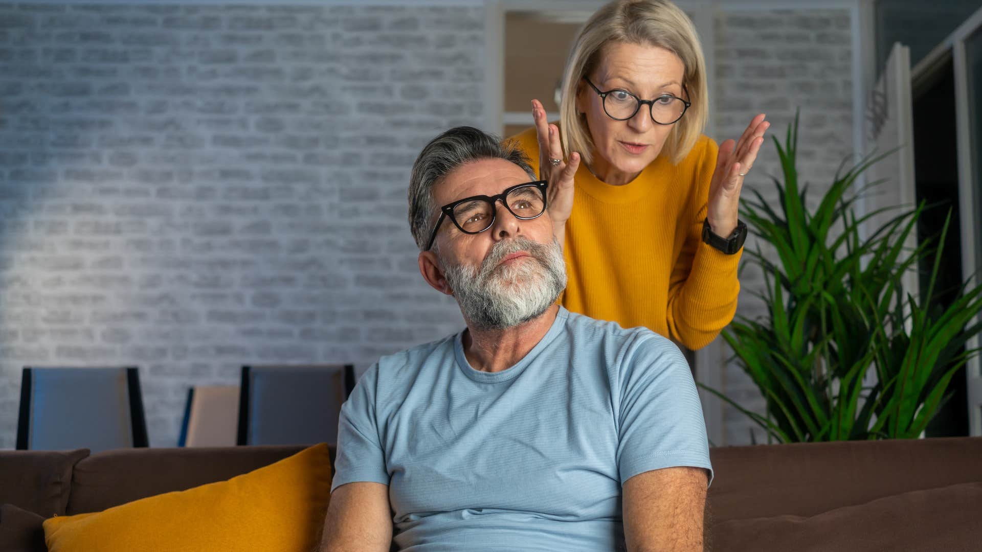 man thinking about anniversaries and birthdays with frustrated wife