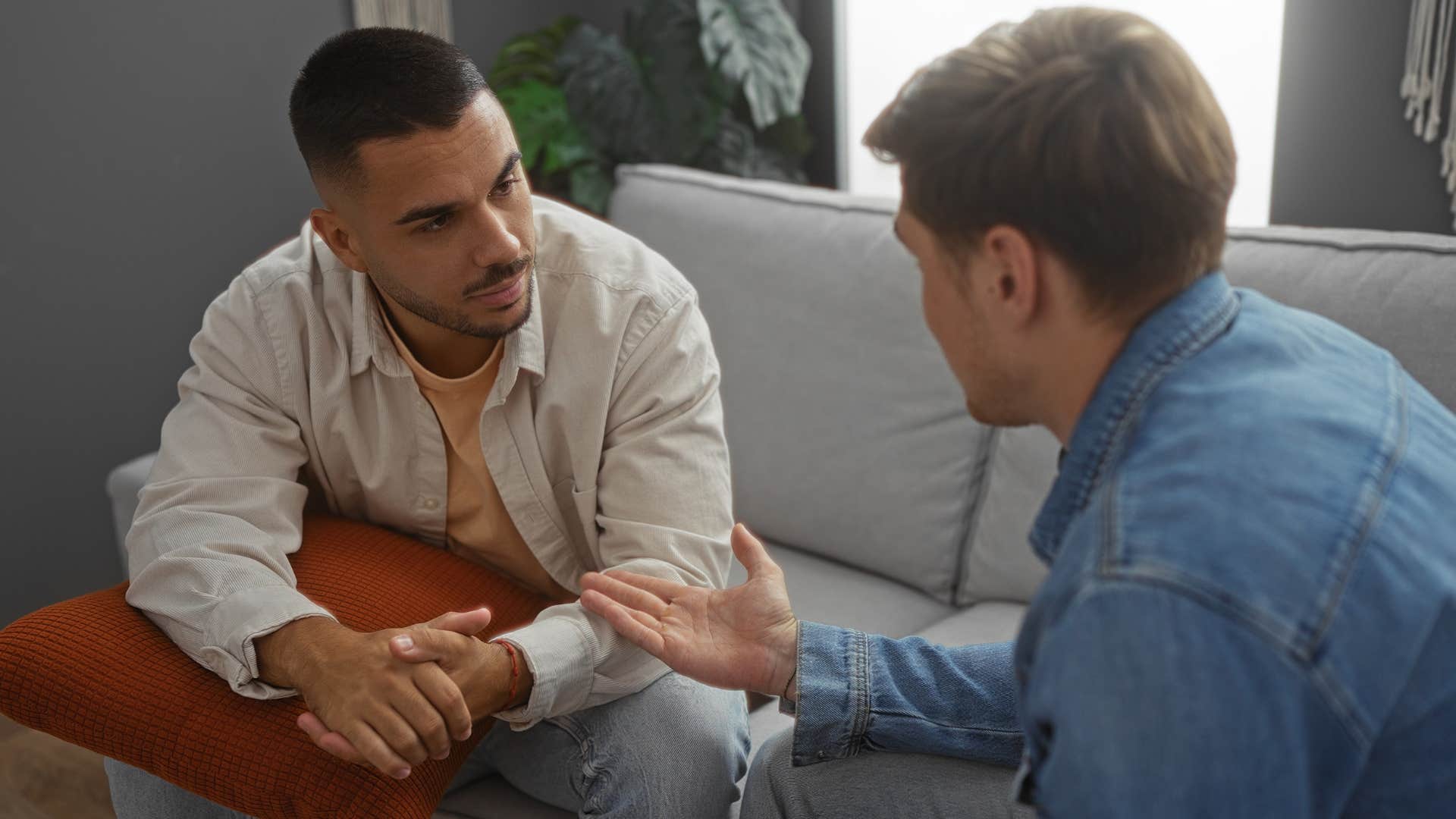 man apologizing talking to a friend