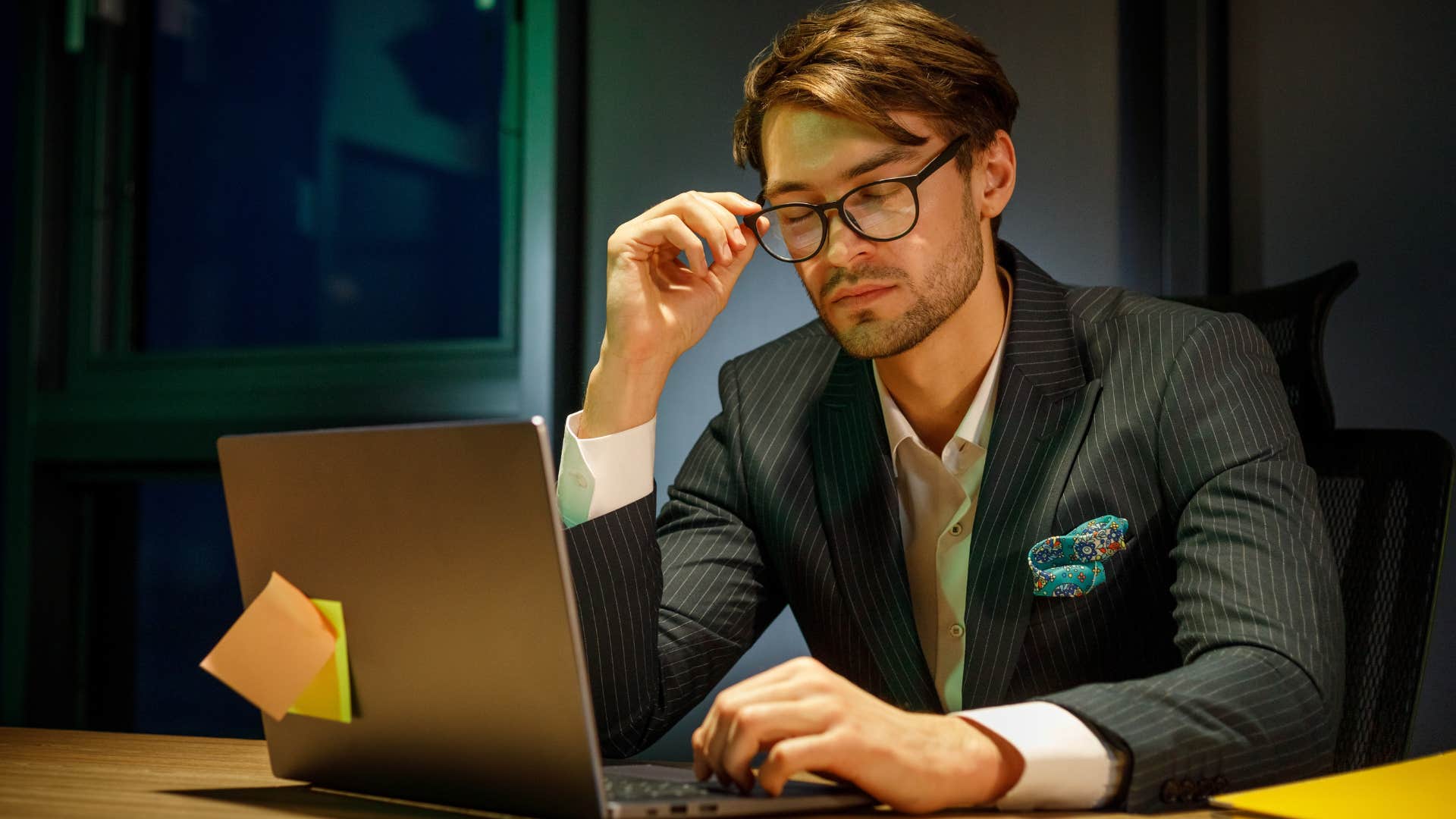 man obsessing over status and materialism in his office
