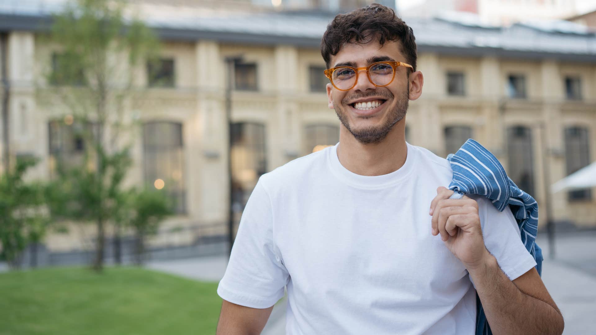 ambitious young man smiling outside