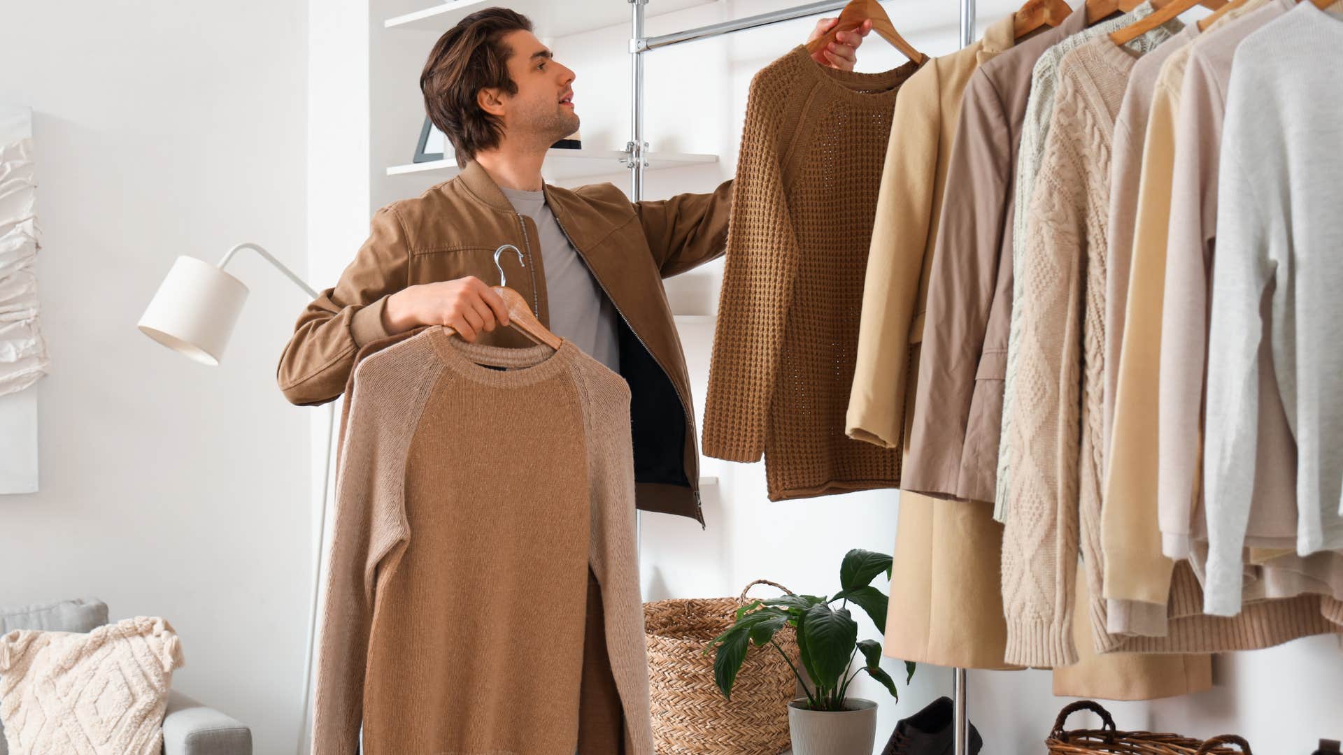 man looking through clothes