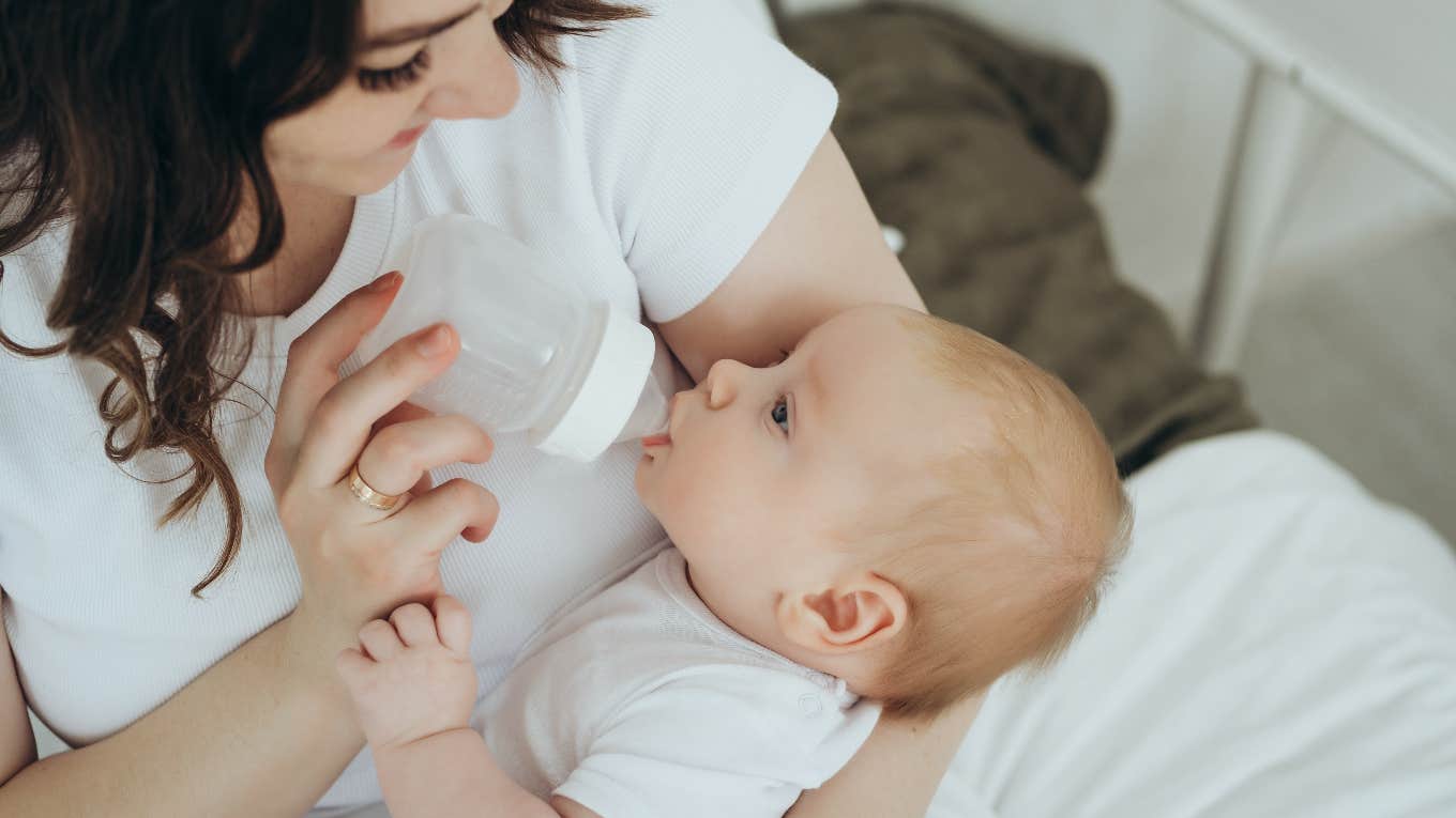 mom feeding her baby formula from a bottle