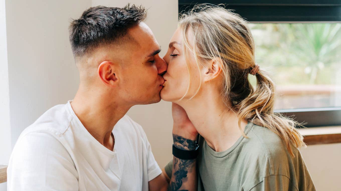“Loving couple sharing a kiss showing how a wife prioritizes her husband and keeps him happy without neglecting their child.”