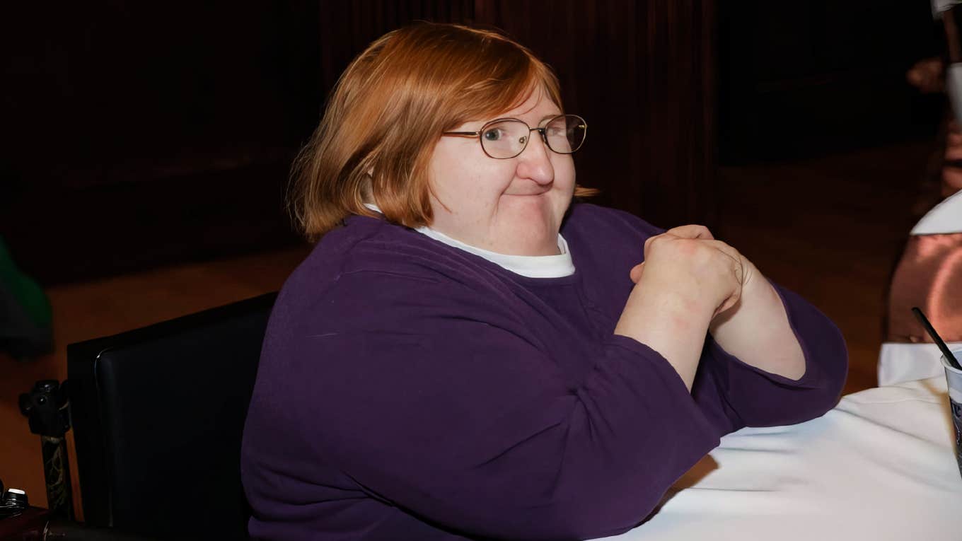 Disabled author smiling in a self-portrait, illustrating how living with a disability can make someone a more compassionate partner.