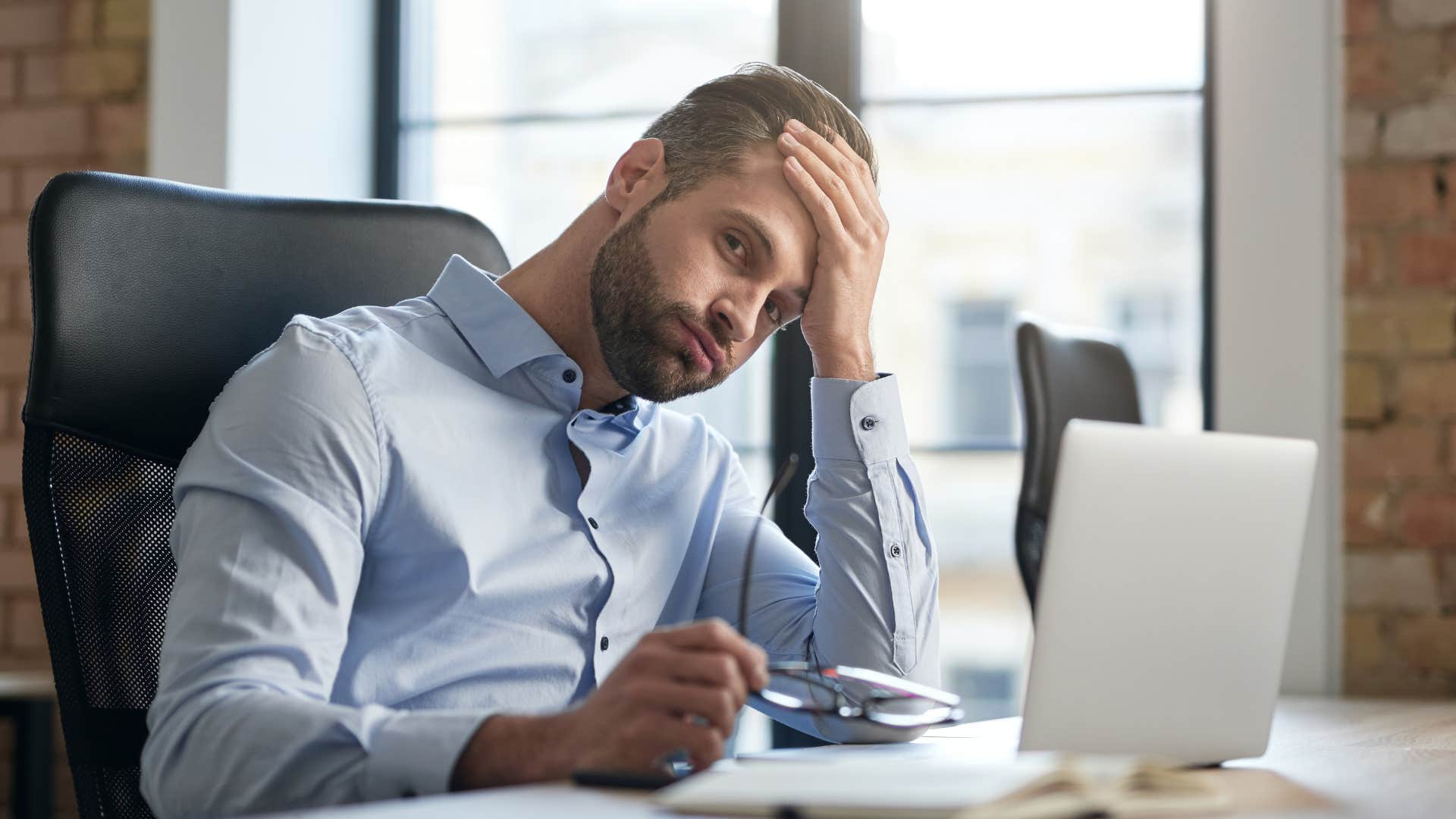 man at working looking tired