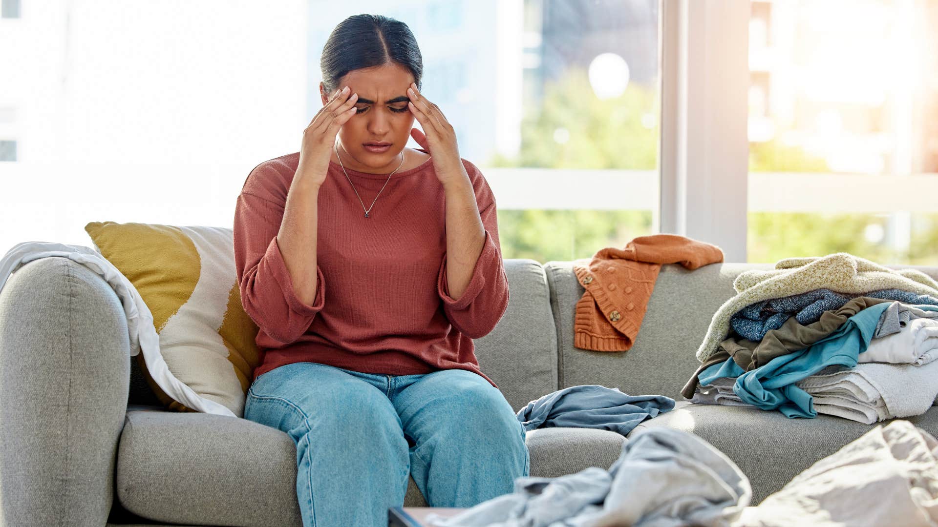 woman wearing the same clothes stressed about a mess