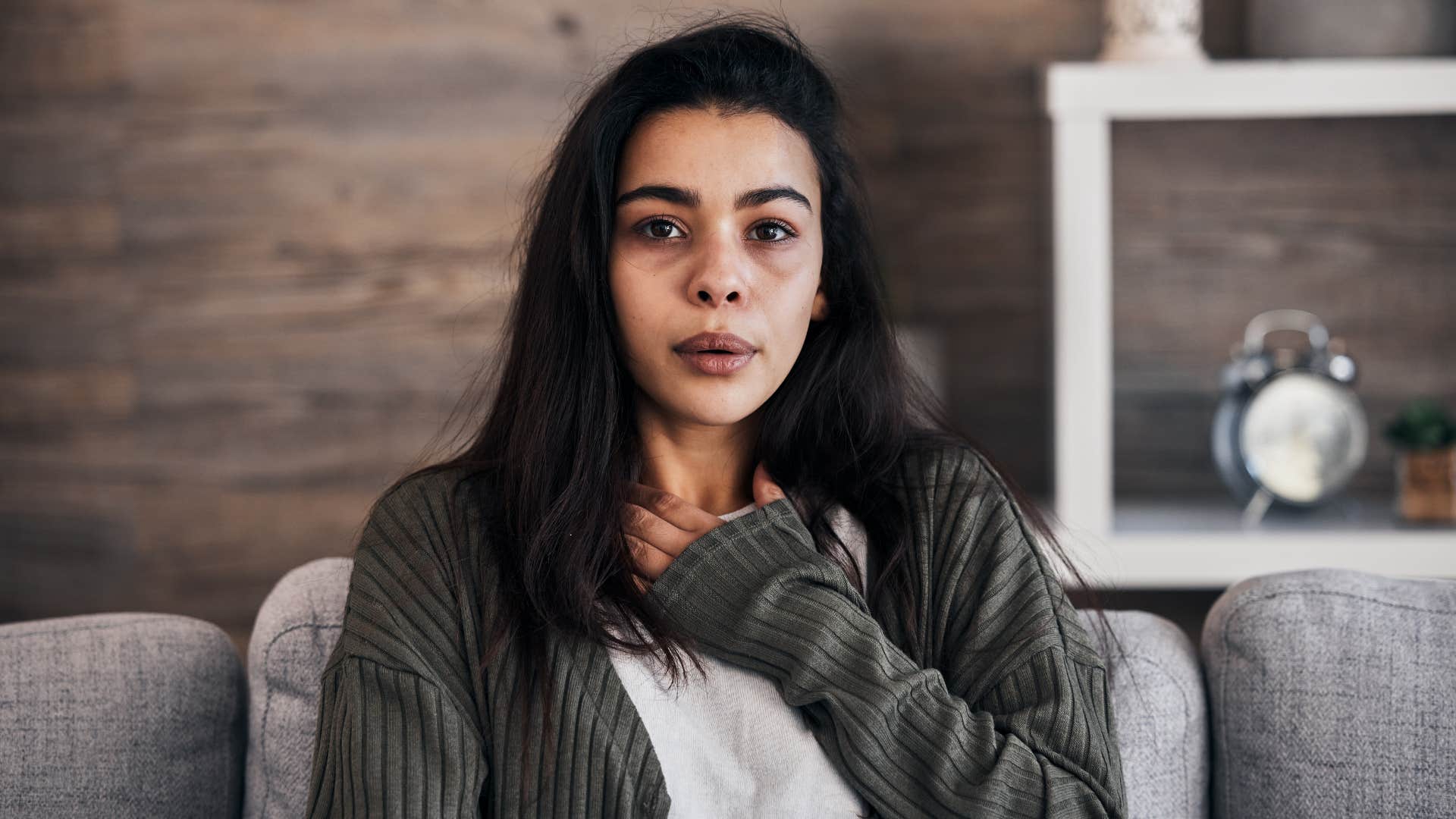 woman not taking deep breaths holding chest