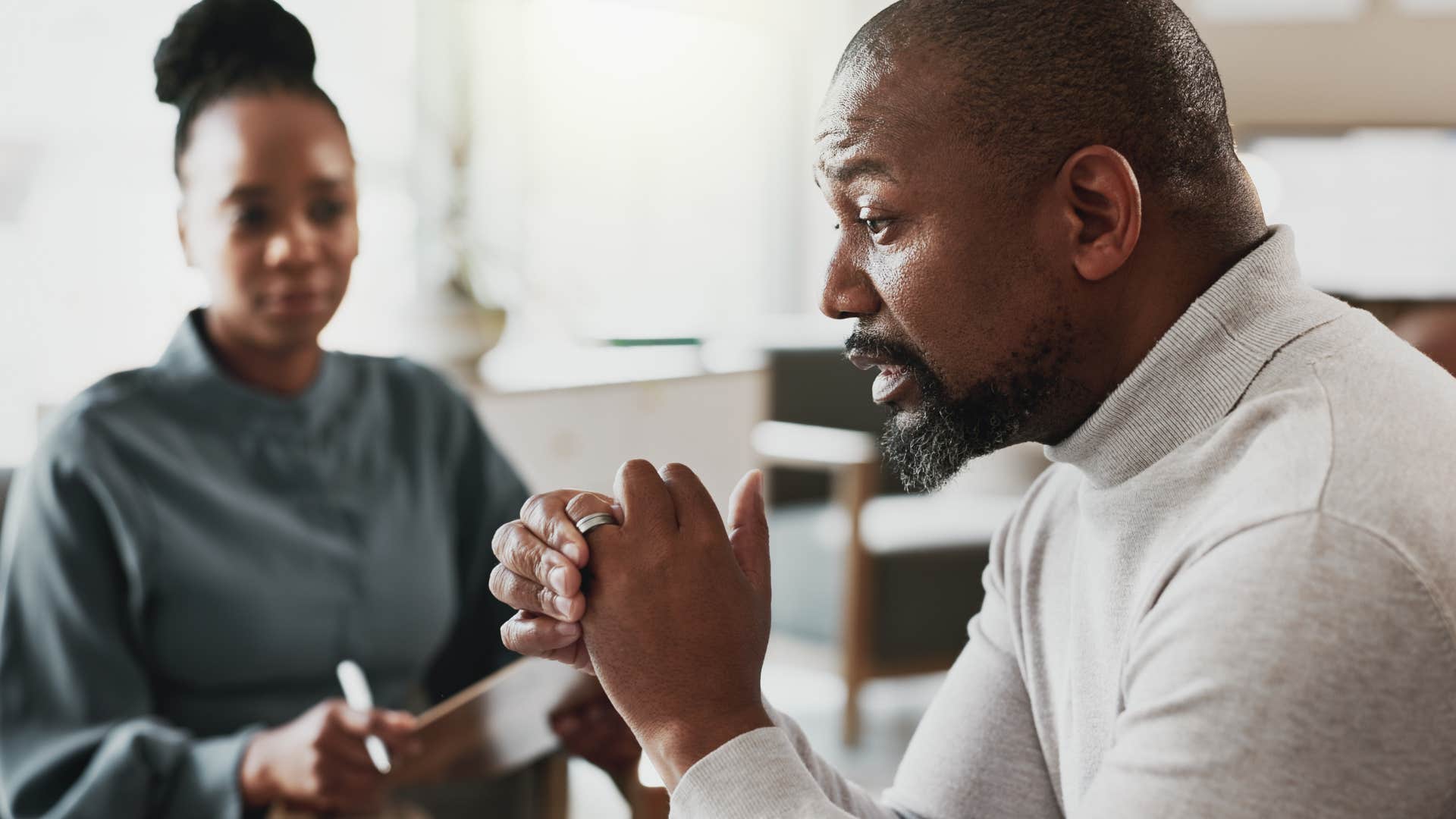 man looking tense and stressed with therapist