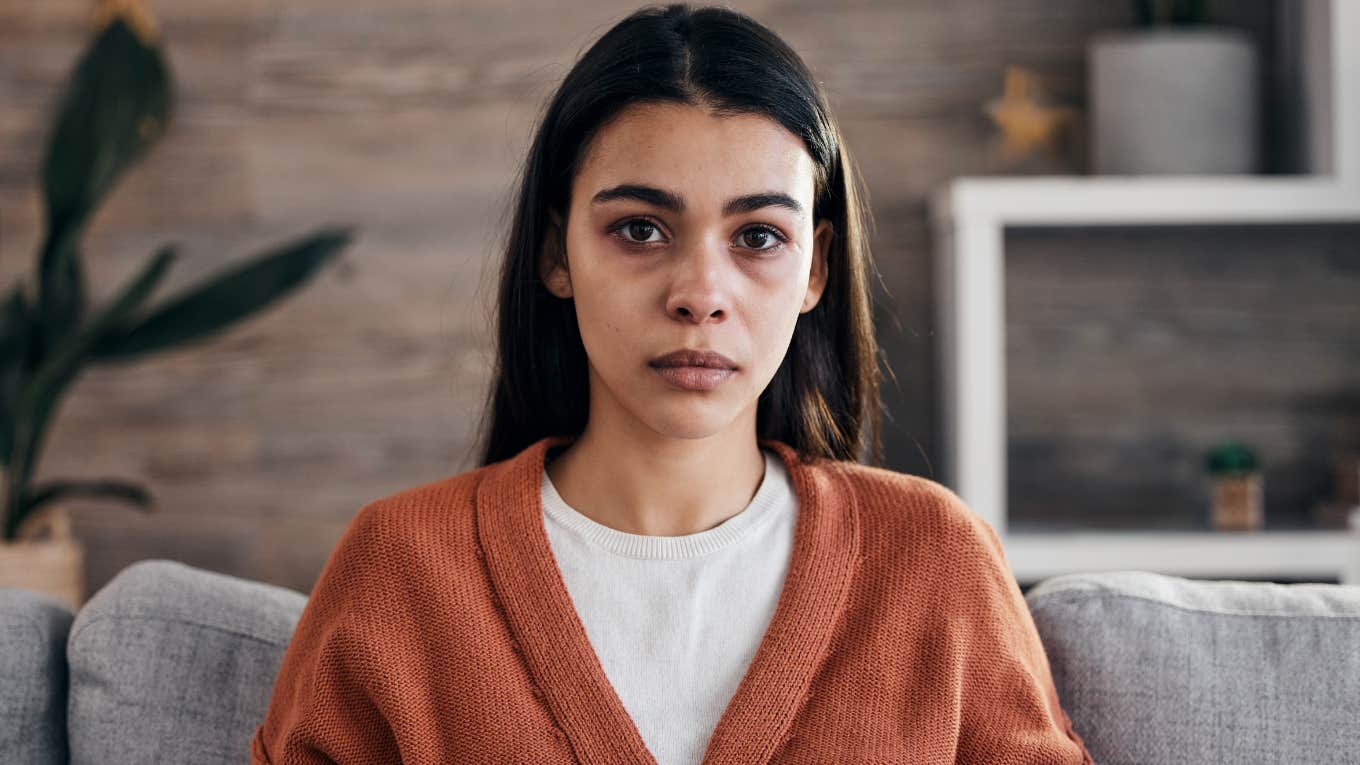 stressed woman looking concerned sitting at home