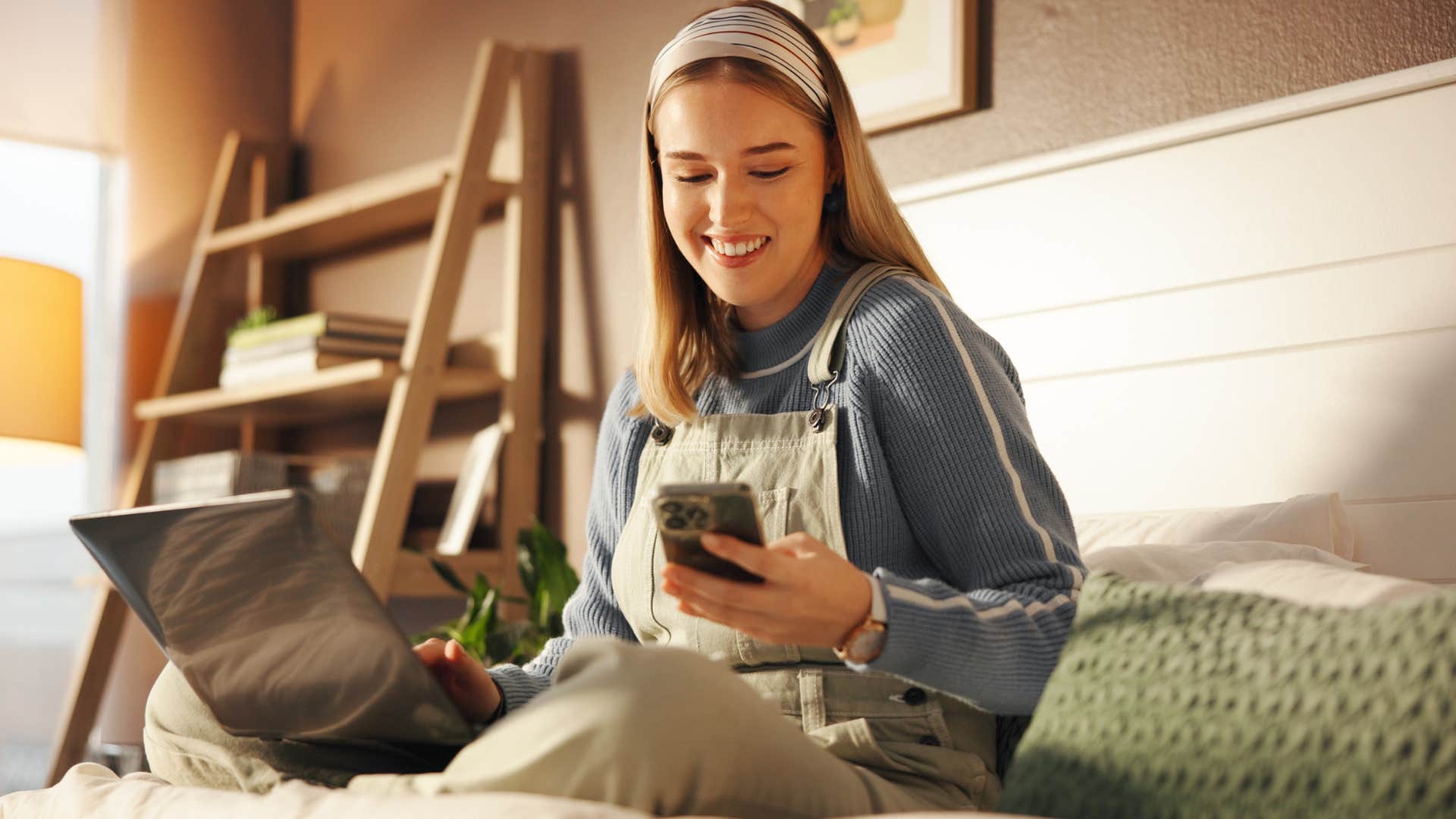 woman sitting in friend's guest room on her computer