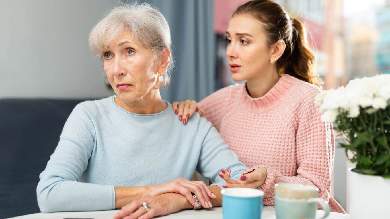 adult daughter concerned for mom sitting in kitchen