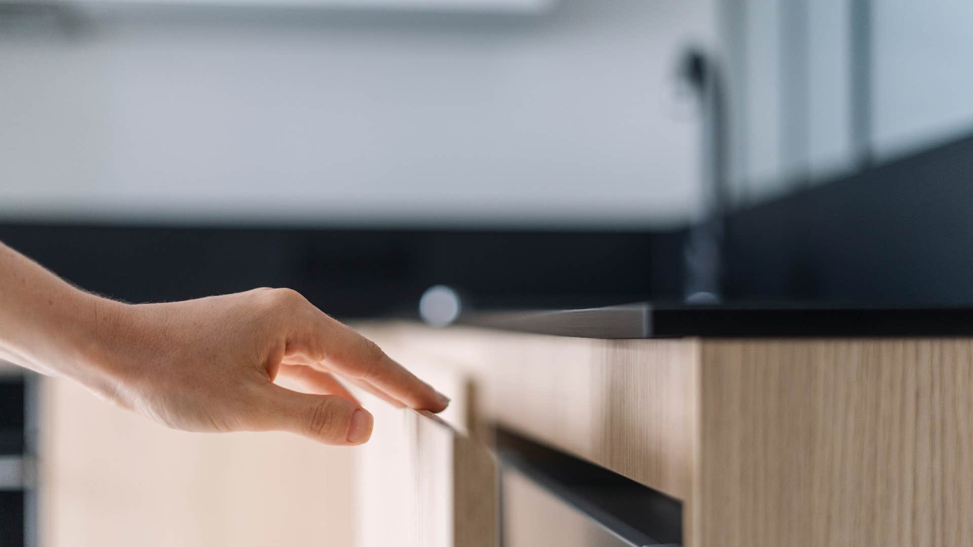 woman opening up a junk drawer