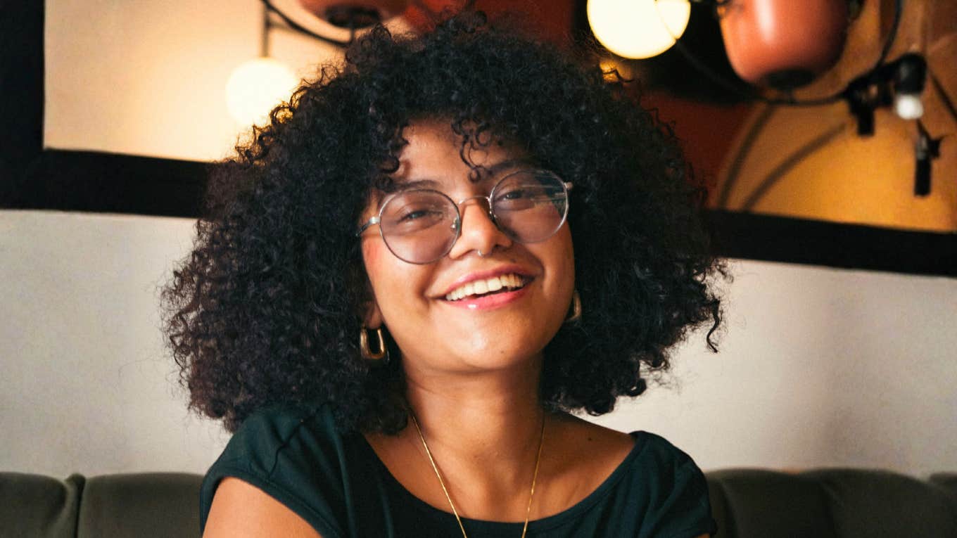 Woman smiling at the camera, reflecting the positive emotional shifts and subtle life changes that show therapy is working.