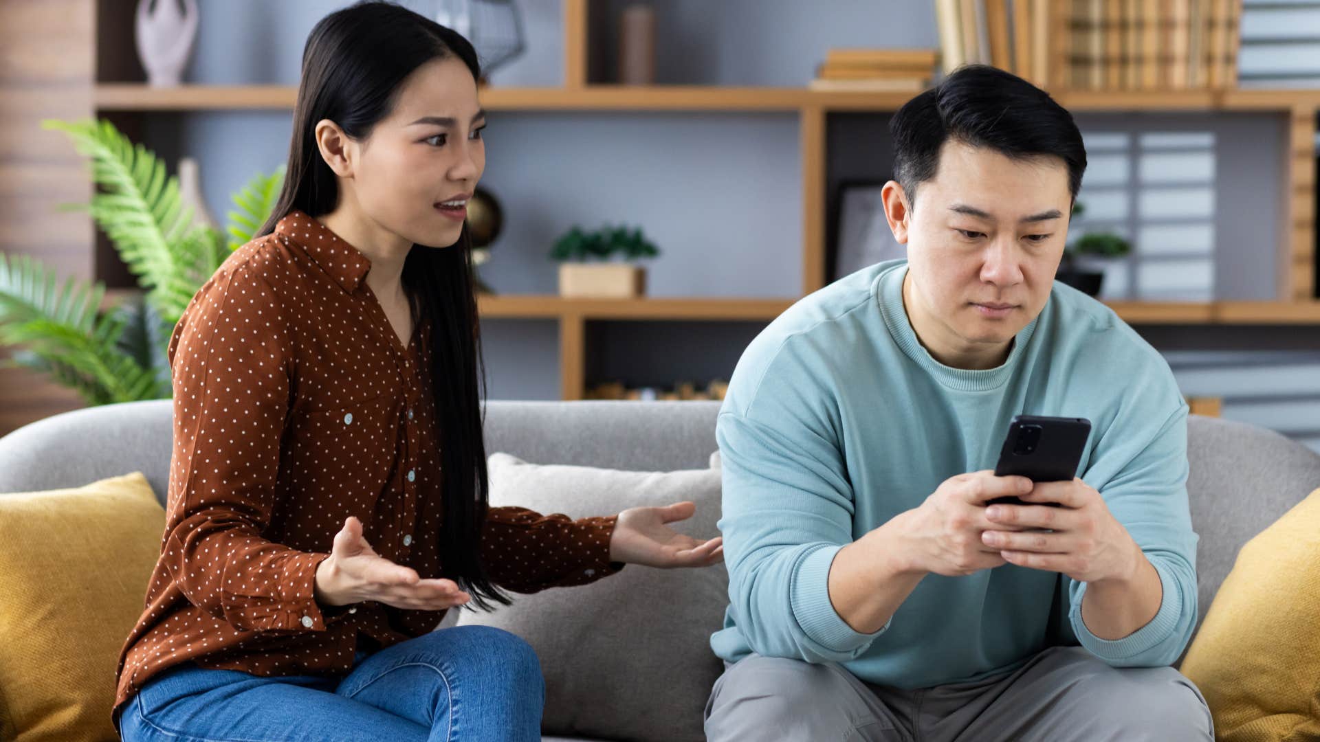 man avoiding topics he doesn't understand looking at phone