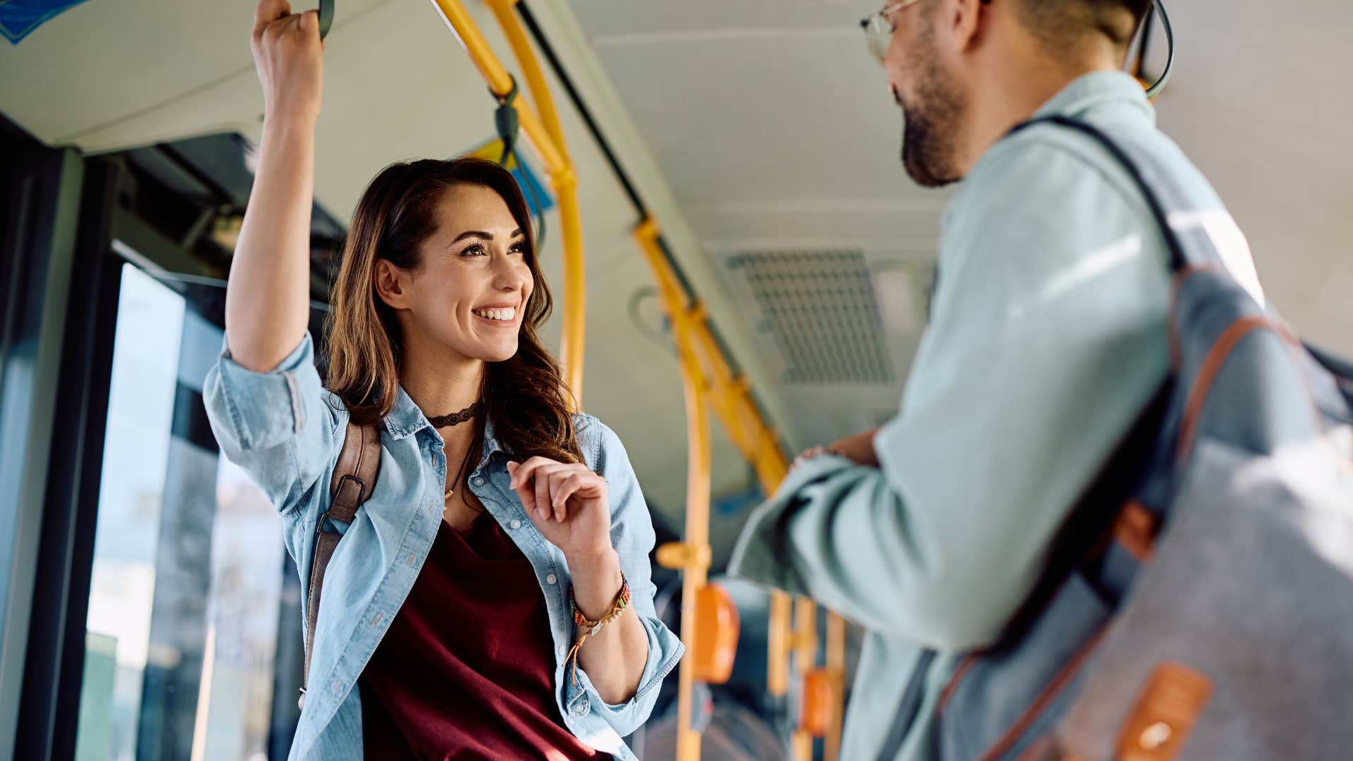 woman with superficial friends talking to a man on the bus
