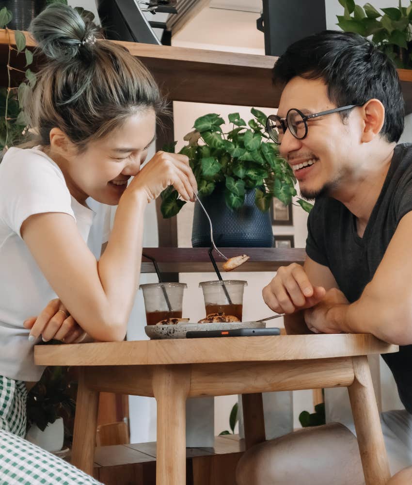 Couple on vacation together eating and falling in love