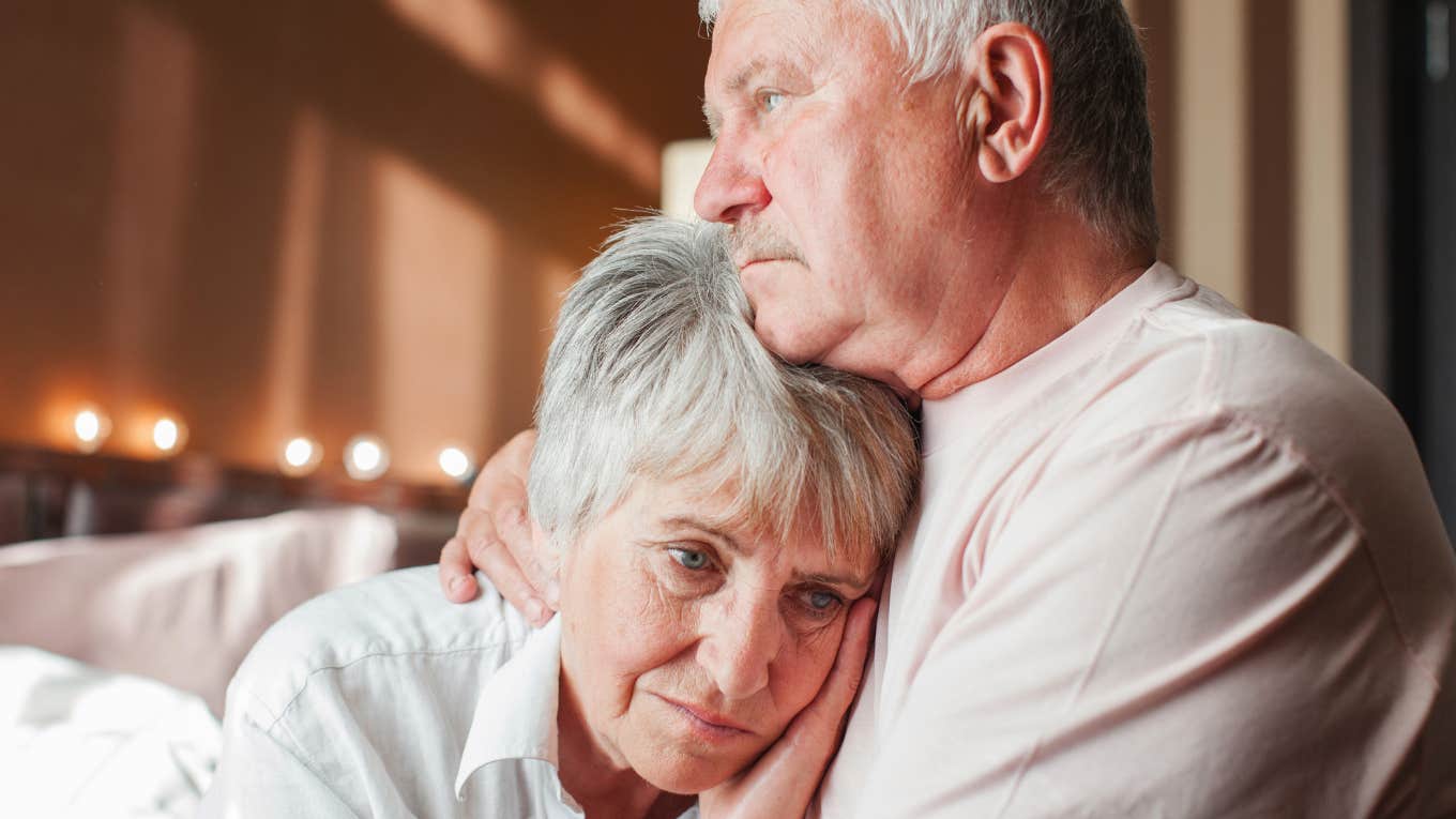 lonely older parents holding each other