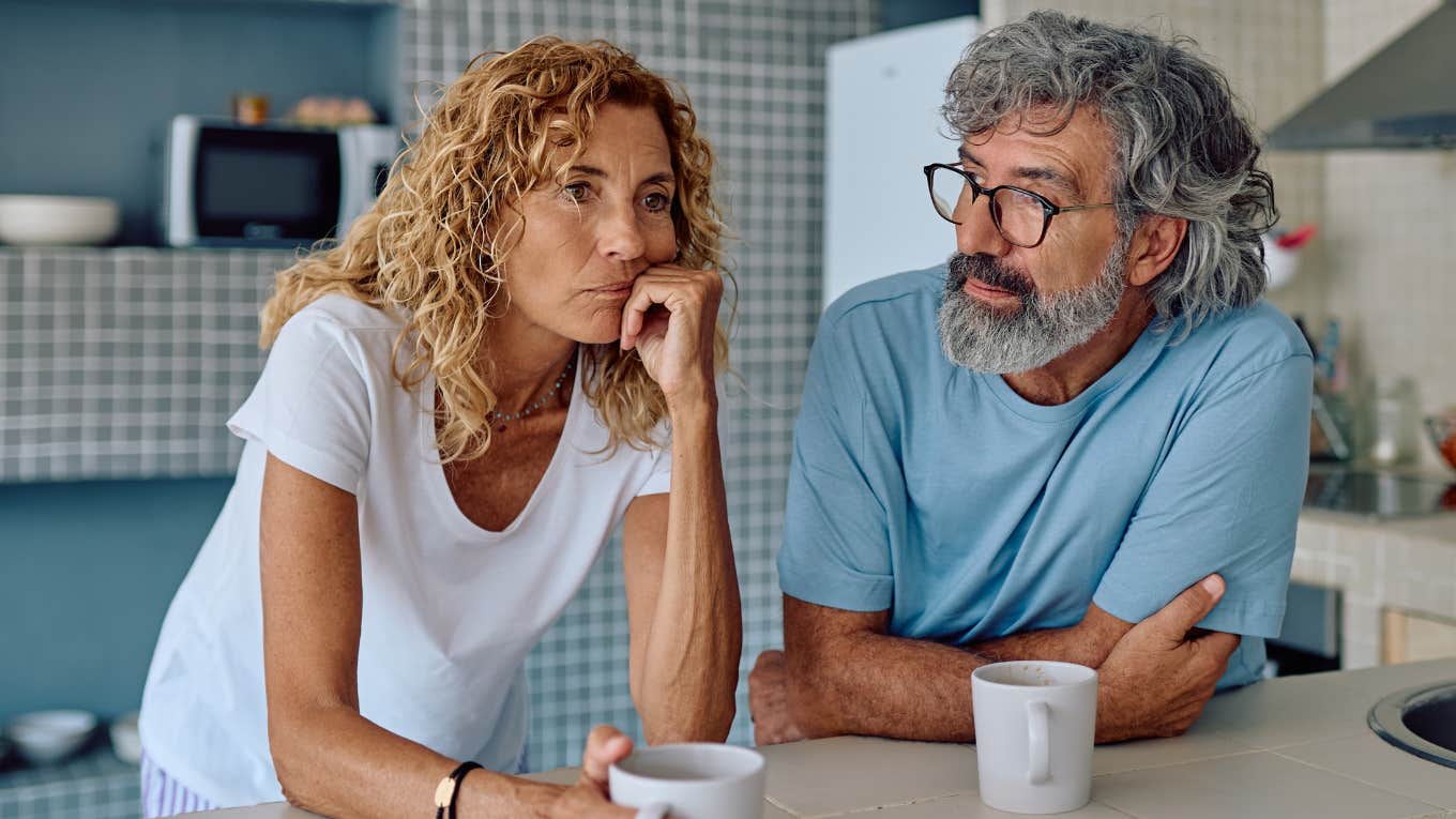 older lonely couple sitting in silence at home