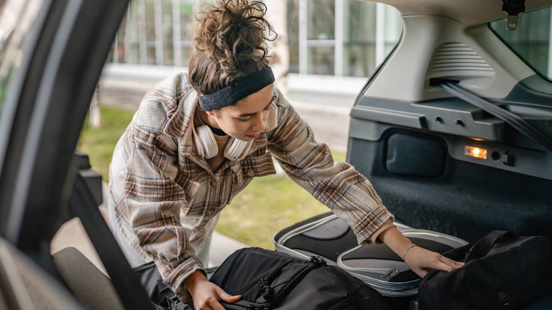 woman packing trunk of car