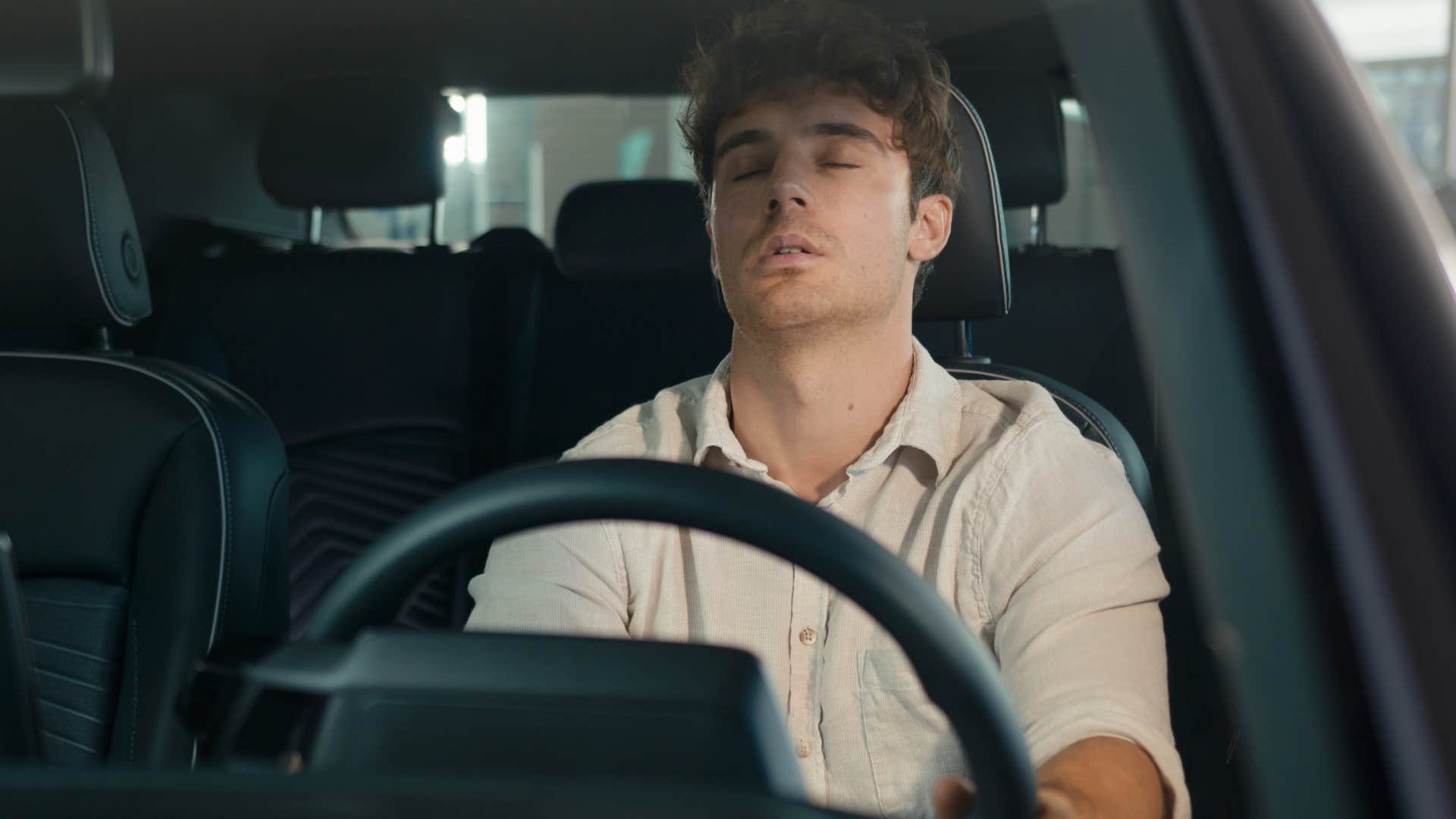 exhausted man in the car making excuses to leave parents house