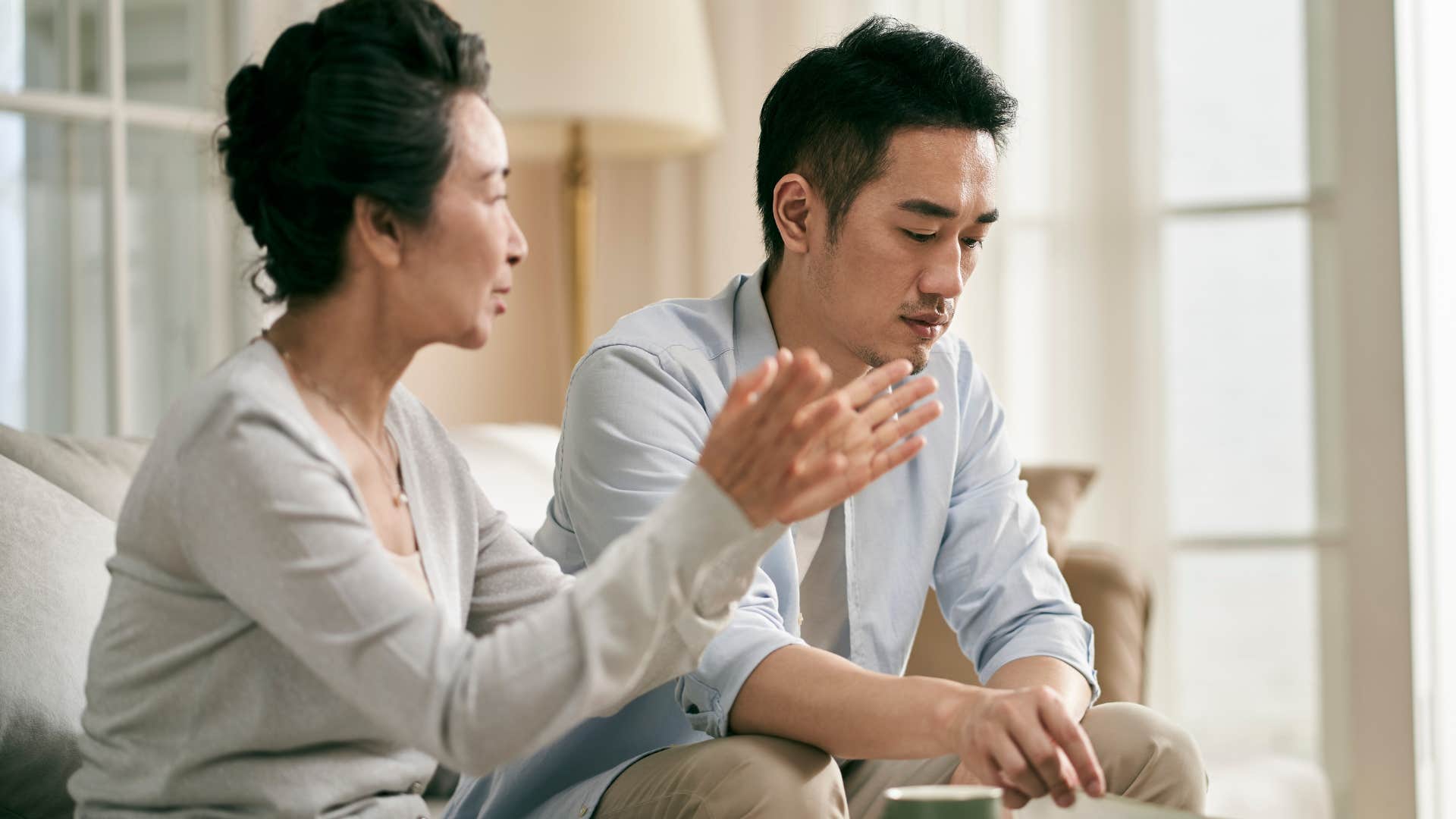 man talking about surface-level things sitting with his mother