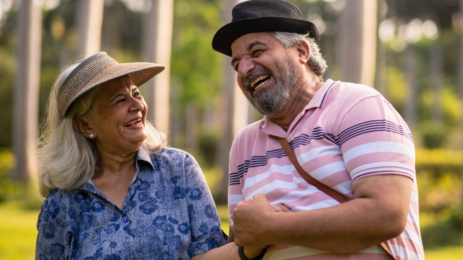 man and woman laughing and joking outside