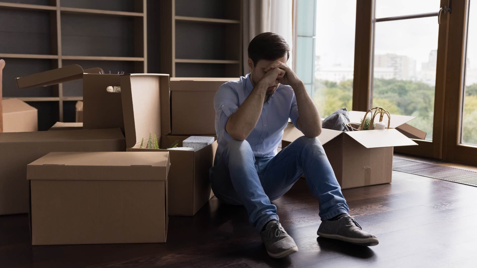 stressed man sitting with empty boxes