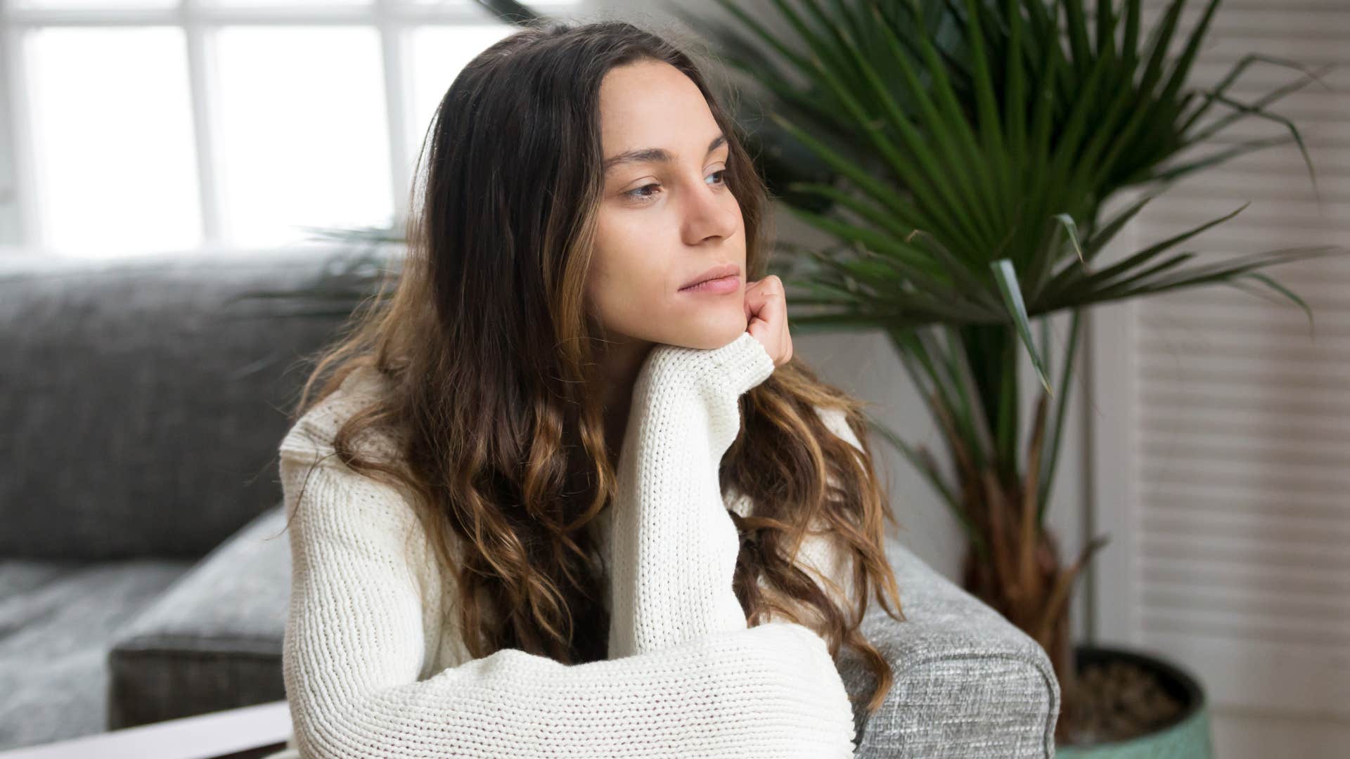 woman sitting in cold impersonal living space