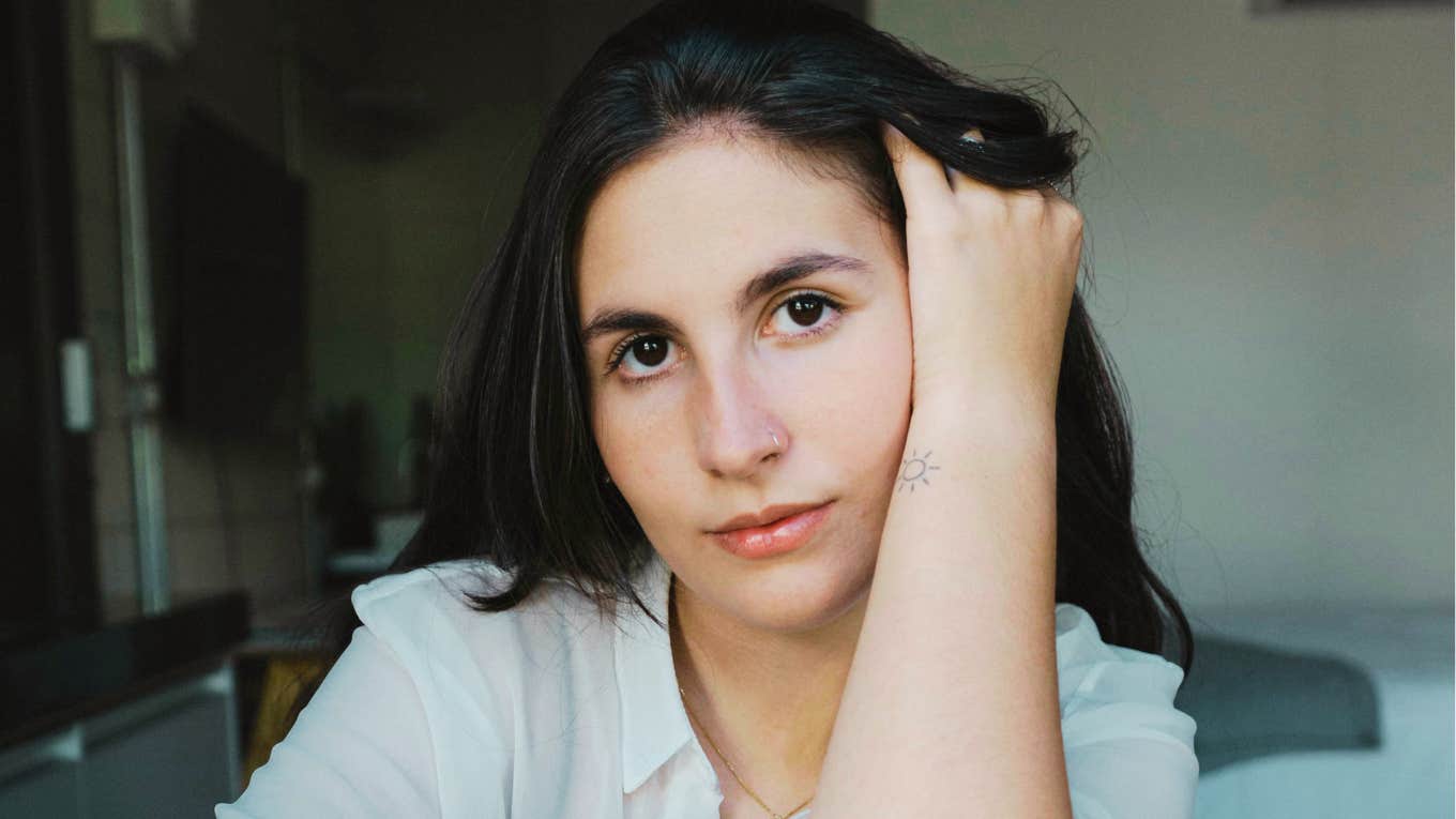 Heartbroken person with hand in their hair staring ahead showing the key emotional ingredient people lack when they can’t shake a toxic ex.