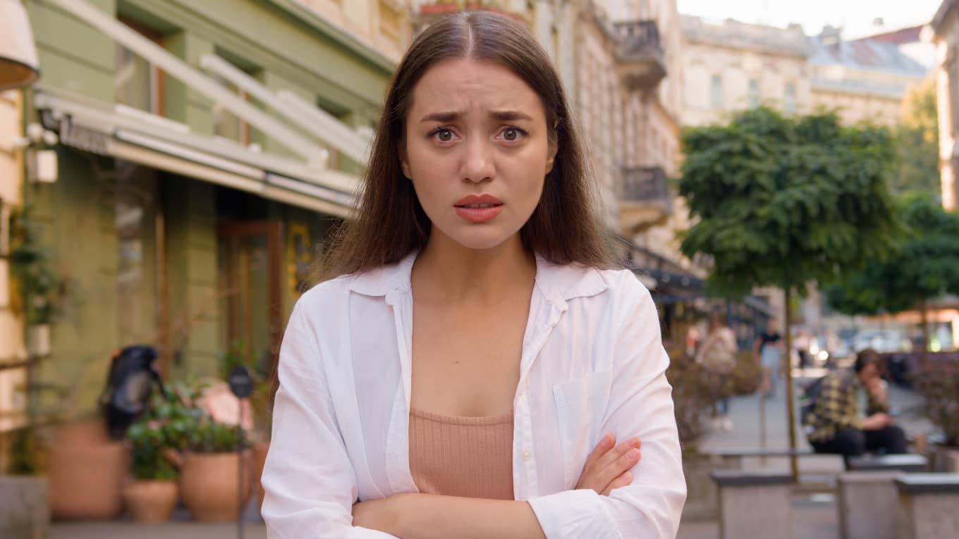 annoyed woman standing on the street