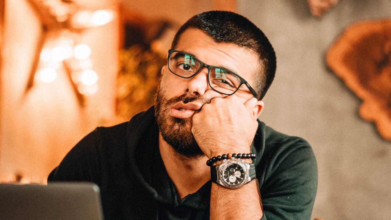 Unmotivated person staring off in boredom, embodying the habits and excuses of people who can’t stop procrastinating.