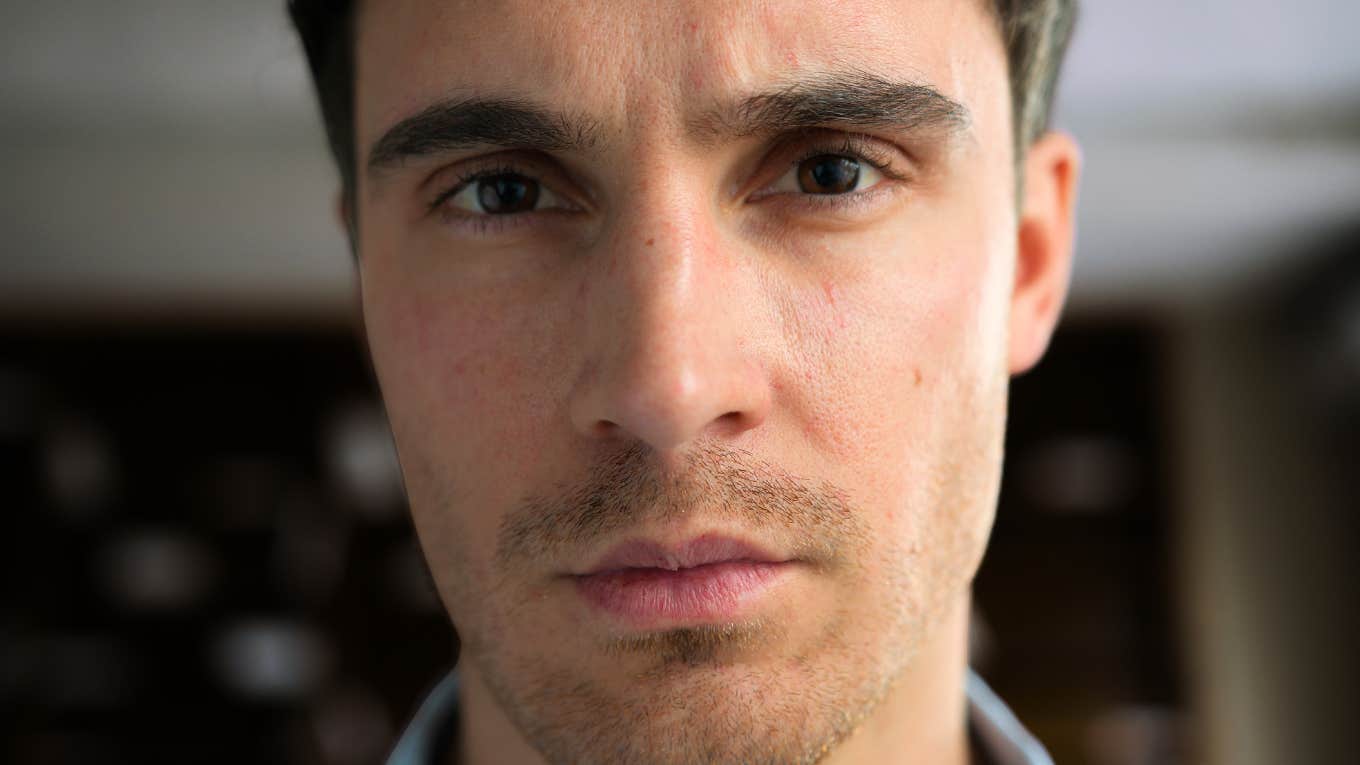 Cold intense person with an unsettling expression showing the subtle warning signs when someone crosses the line from narcissist to sociopath.