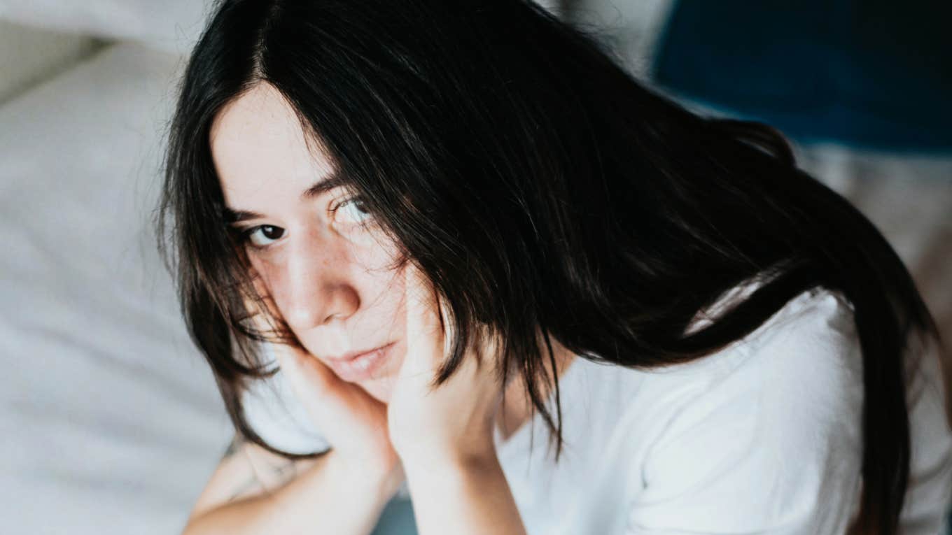 Overwhelmed person showing the messy habits people with executive dysfunction say feel way too familiar.