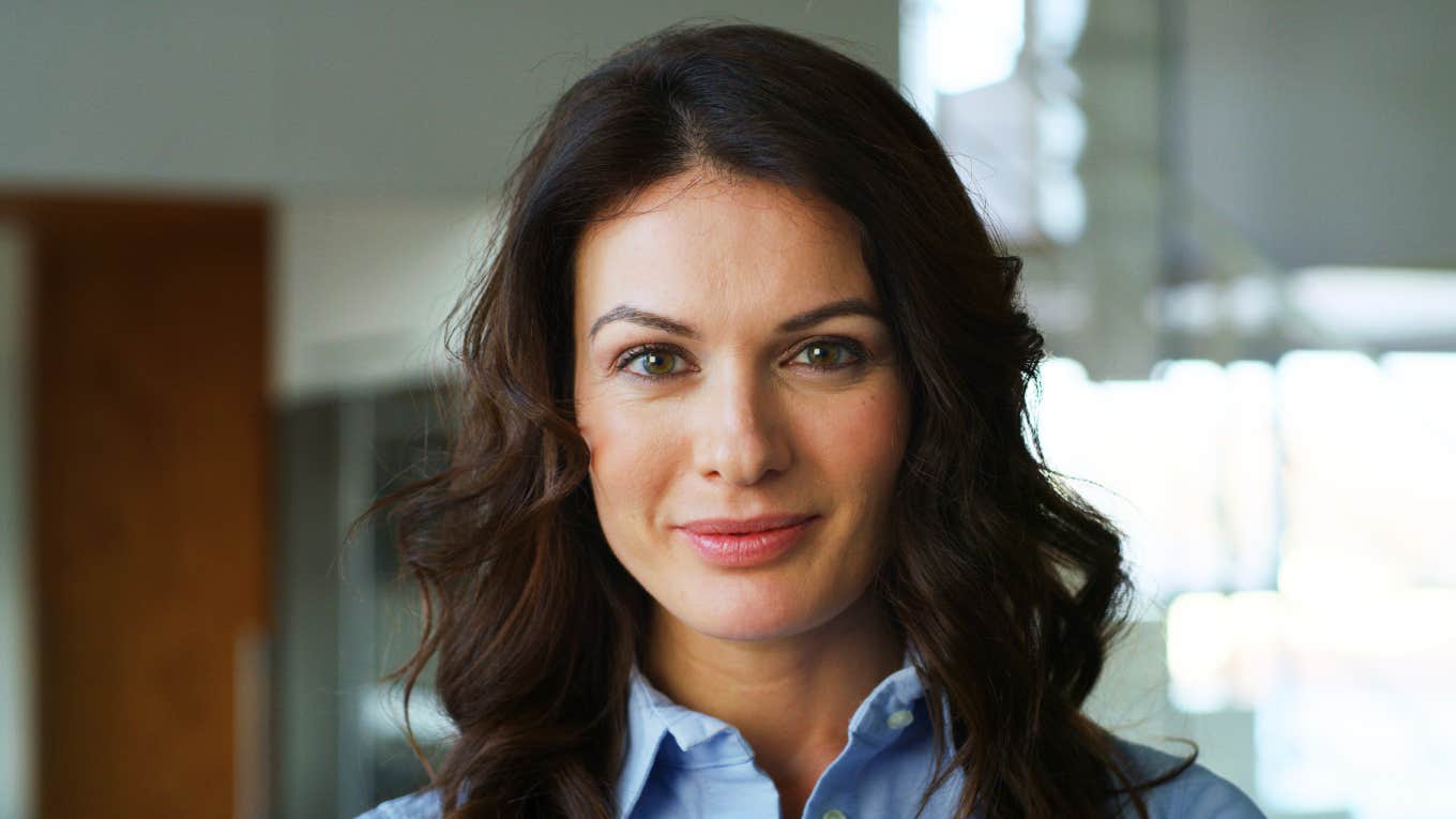 Confident professional woman smiling with purpose, embodying the energy of people who reinvent their careers later in life.