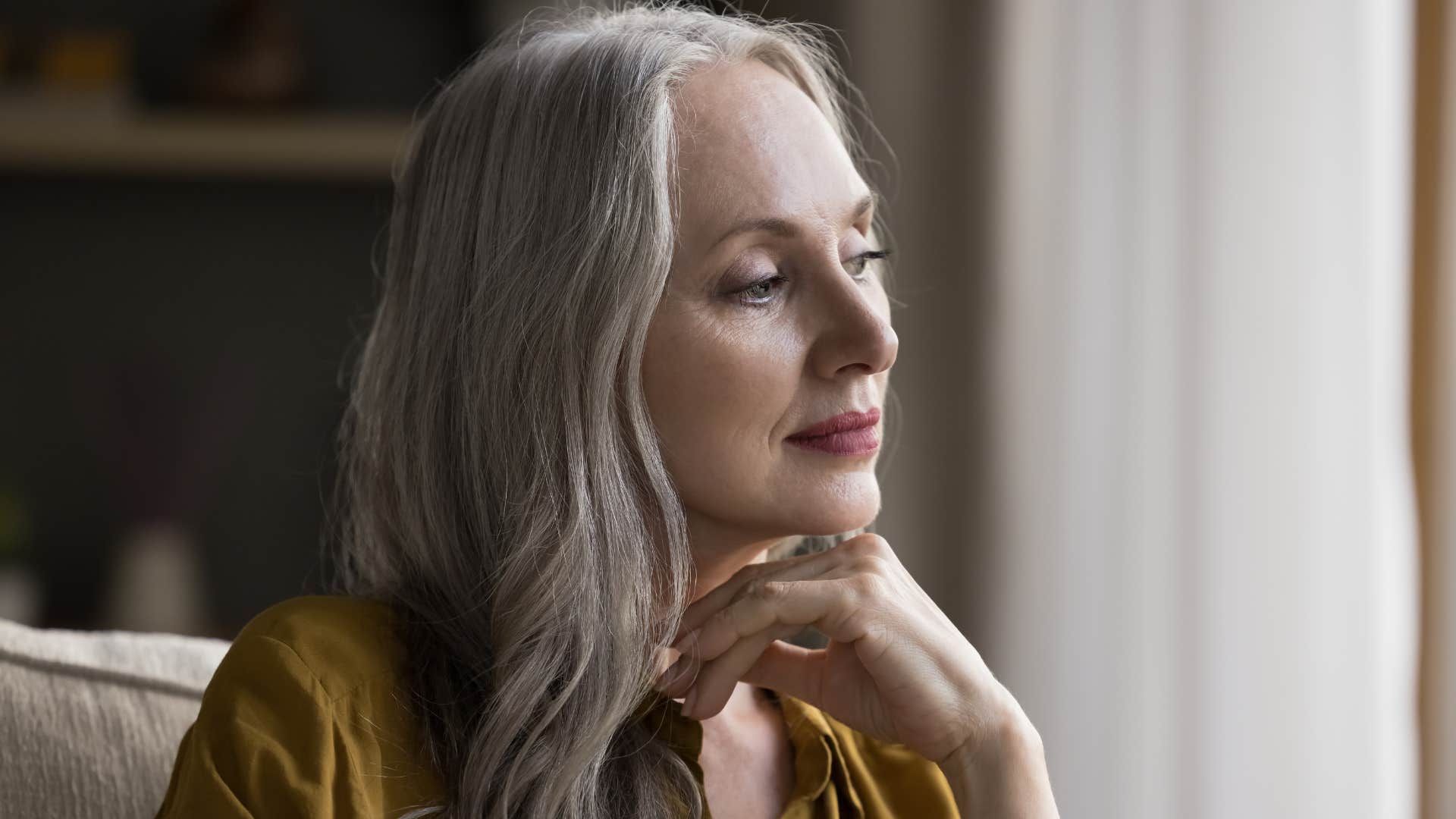 middle aged woman hiding her exhaustion smiling