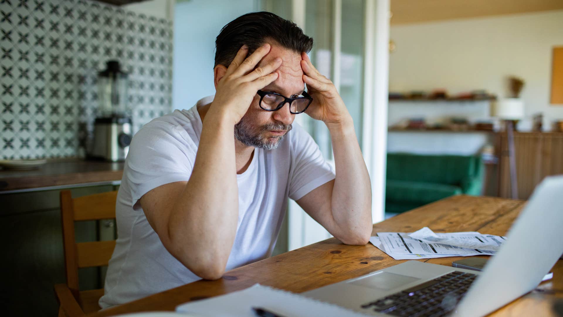 middle aged man stressed overworking himself