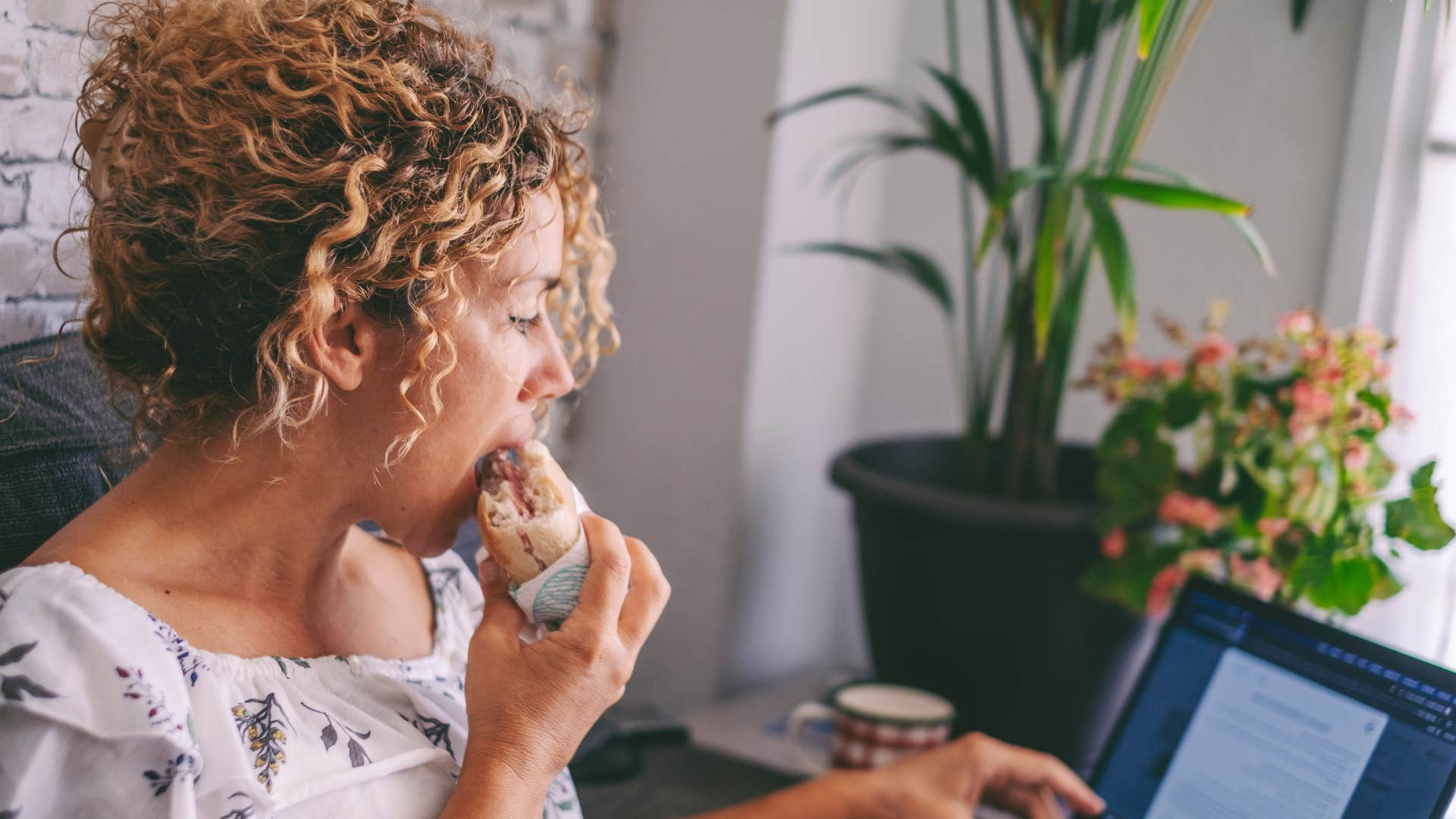 woman eating while she works