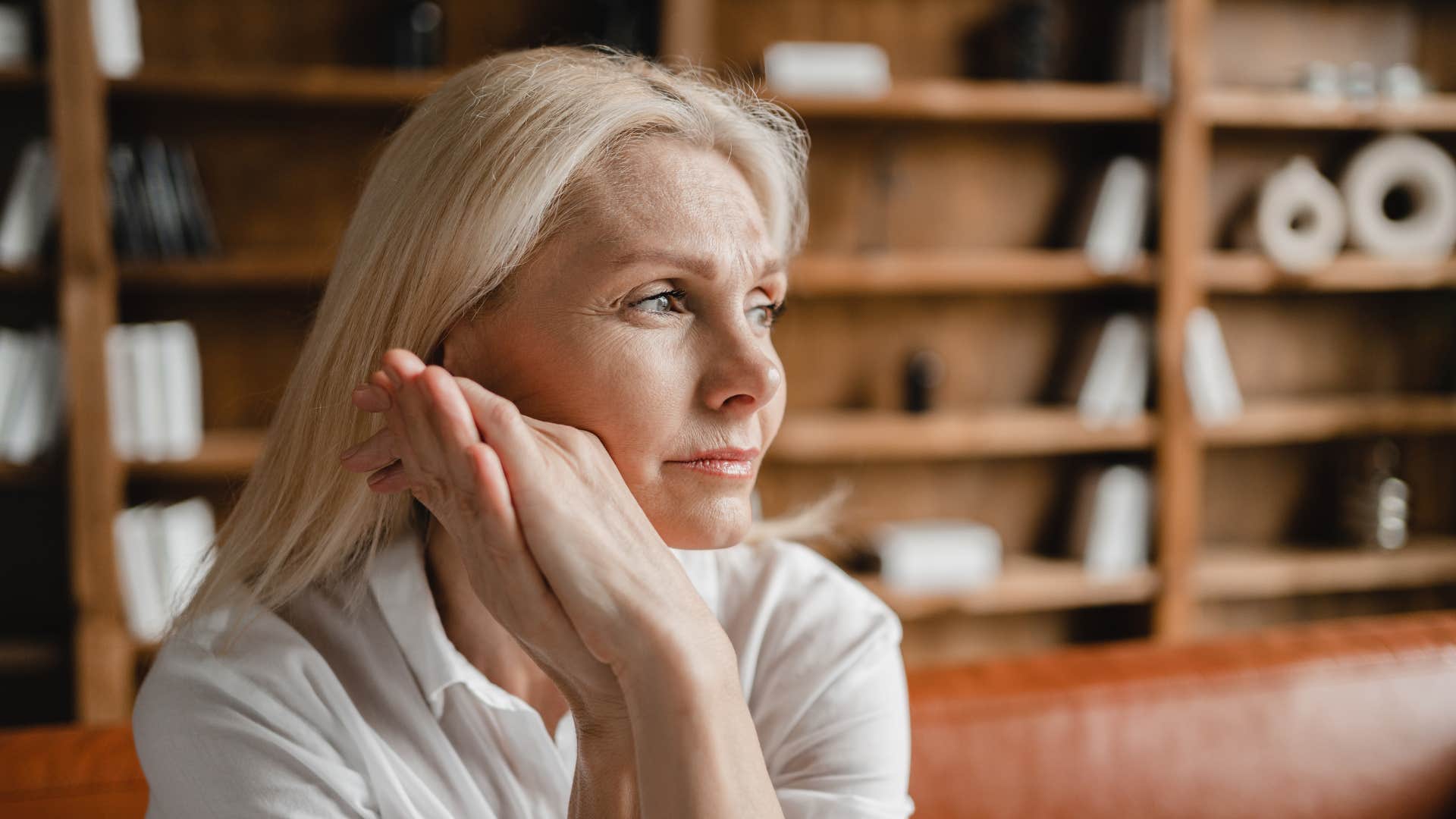 sad middle aged woman thinking about latchkey childhood