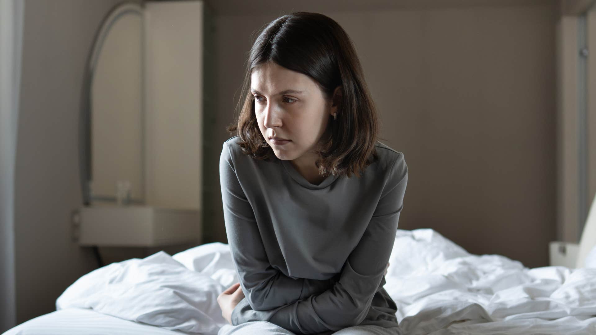 woman in gray shirt looking done as she deals with low-level depression or burnout