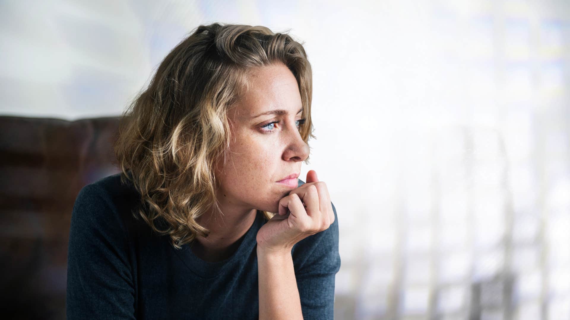 woman staring off to the side as she silently protests