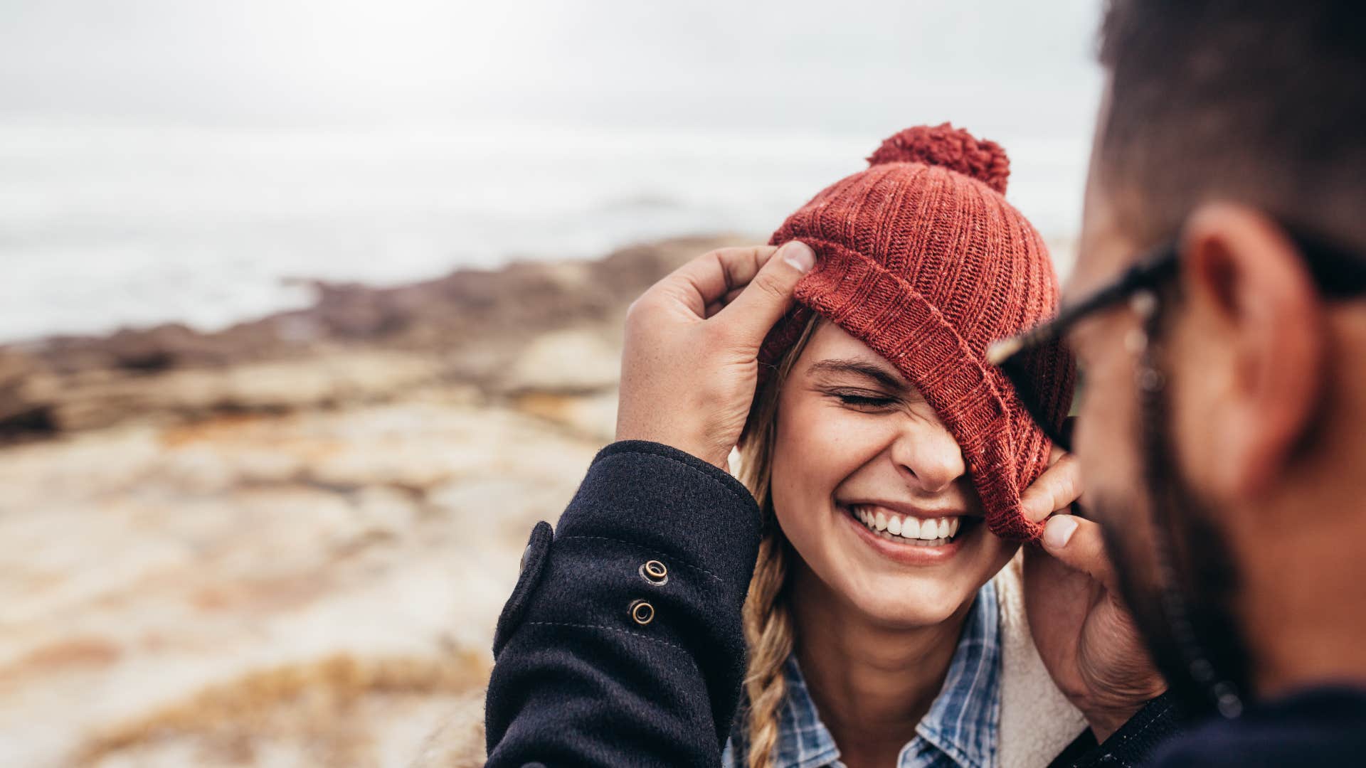 woman smiling at man as they have an inside joke