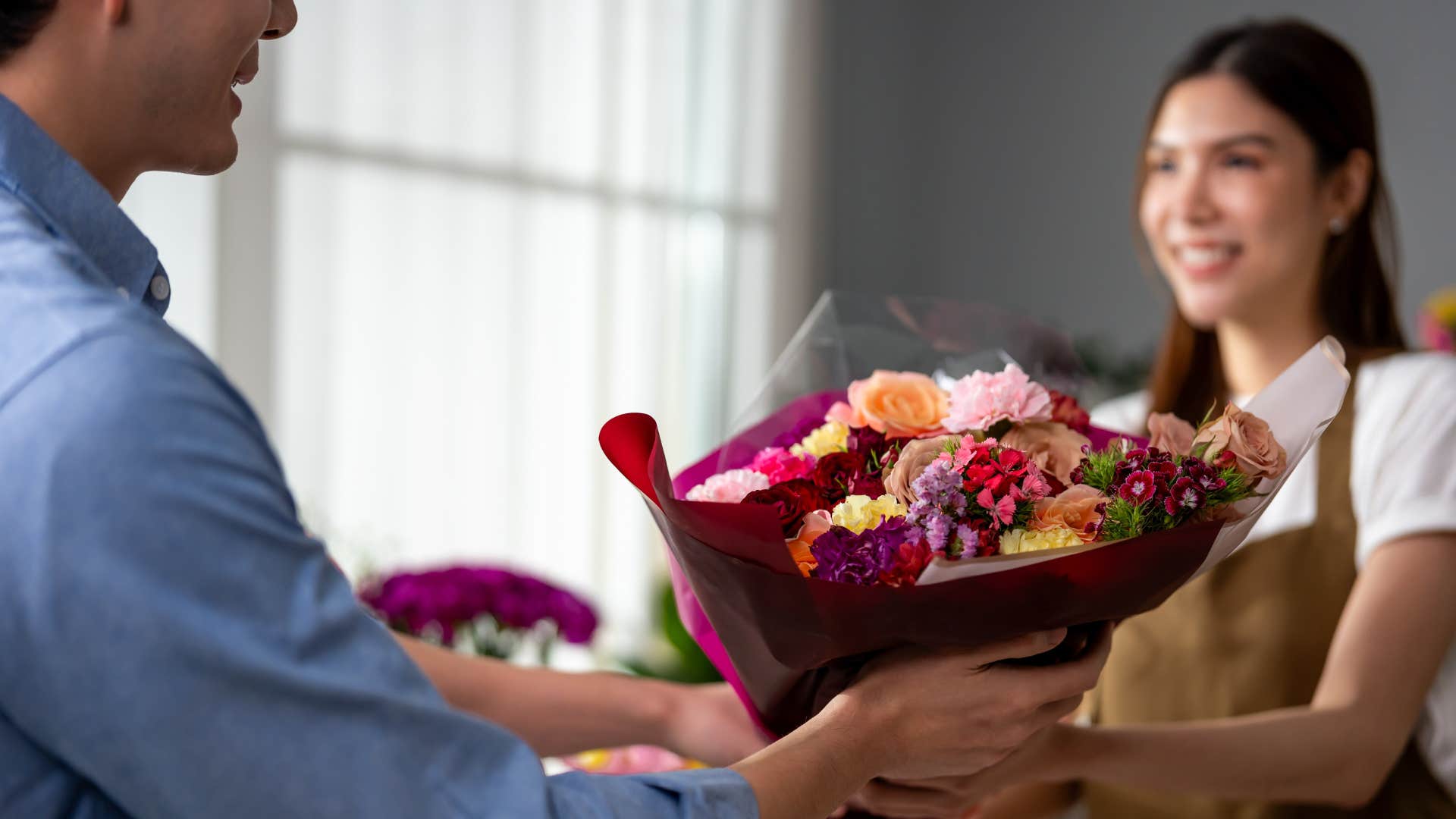 man buying flowers from woman as he is learning to reignite the spark