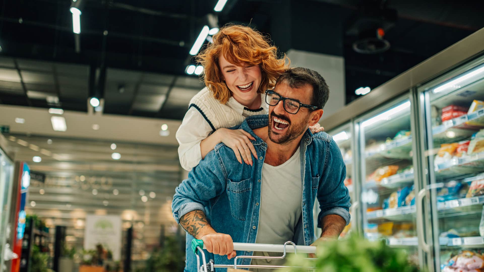 couple going grocery shopping and joking around as they do life side by side