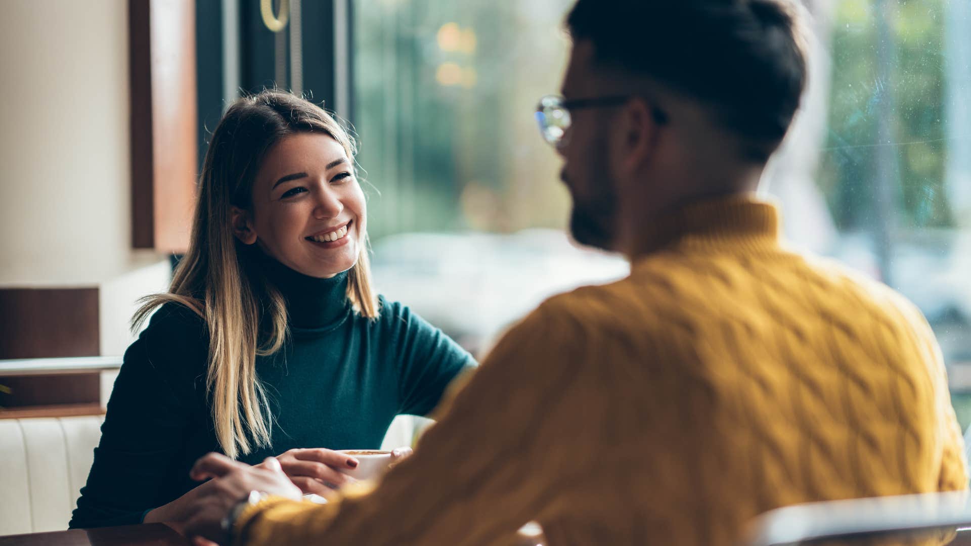 woman in green listening to man as they have a shared history that keeps on expanding