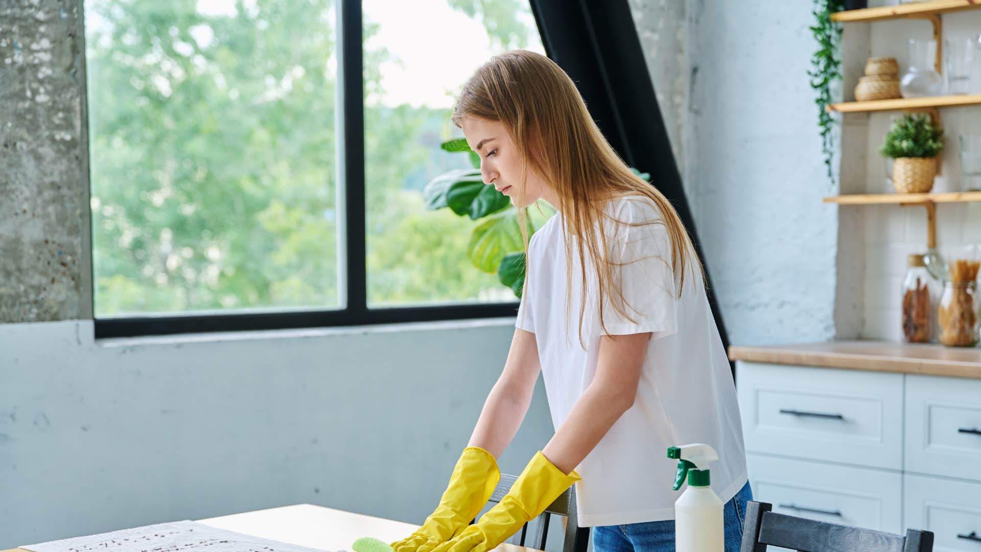 woman cleaning table after being taught that comfort must be earned