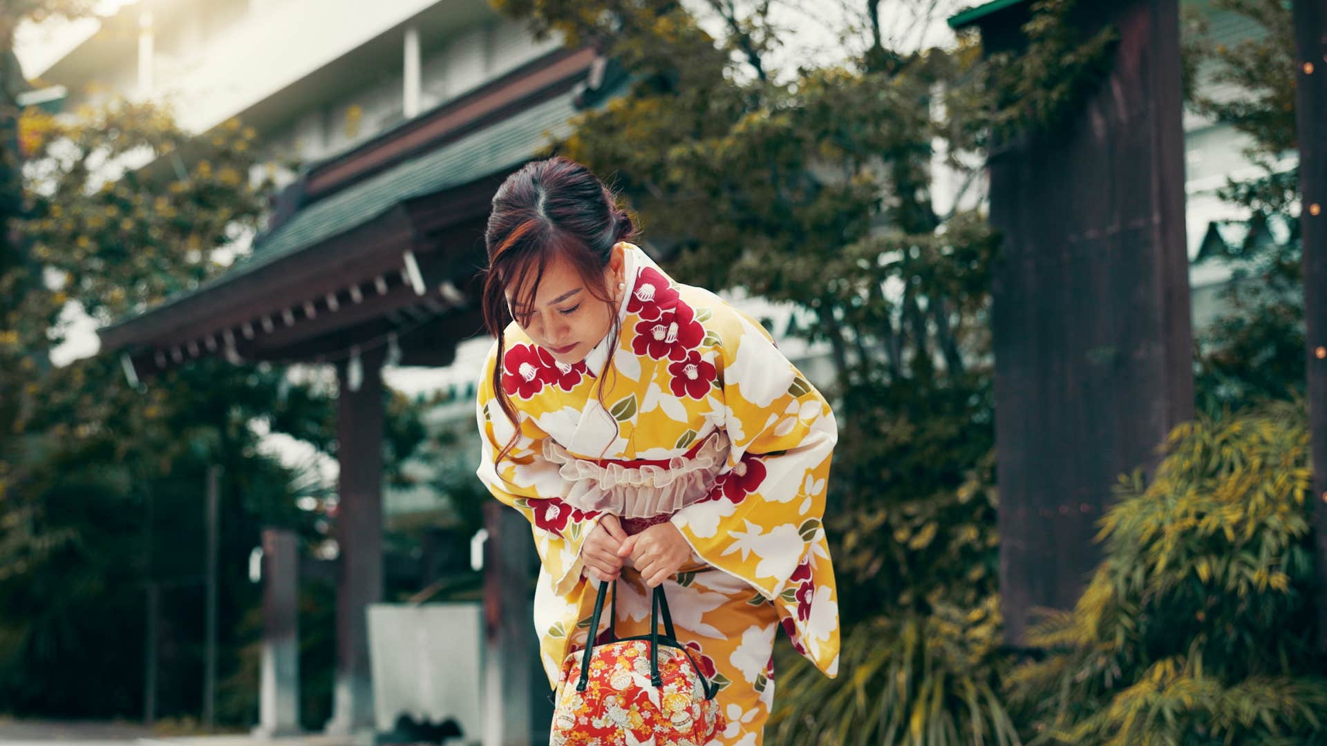 woman bowing as hugging is not part of her cultural norms