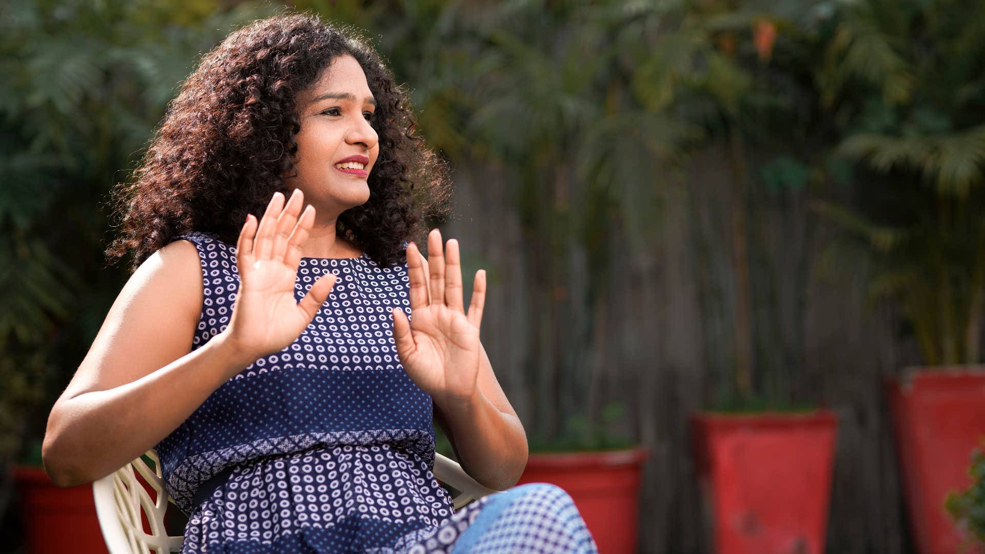 woman holding up hands as she wants to avoid mixed signals 