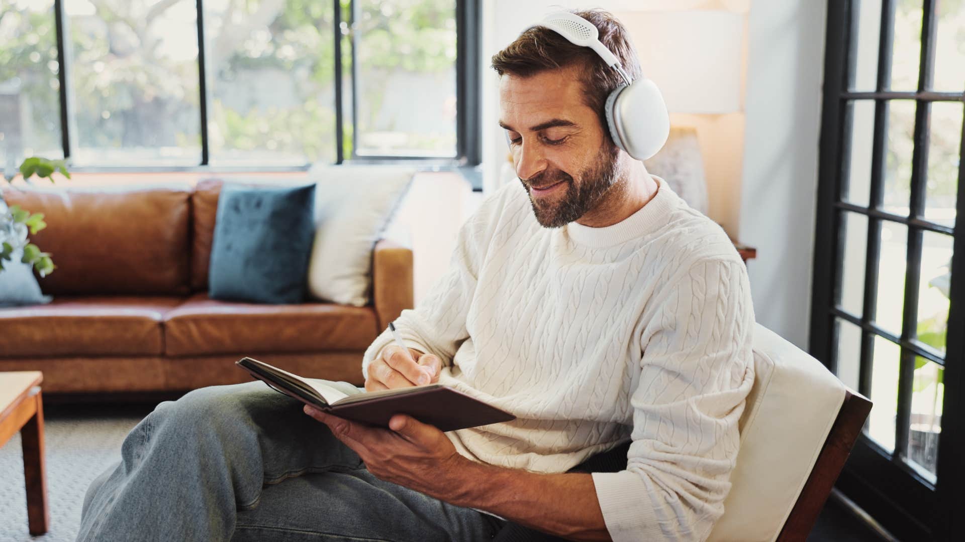 Man who craves slowness writing at home alone.